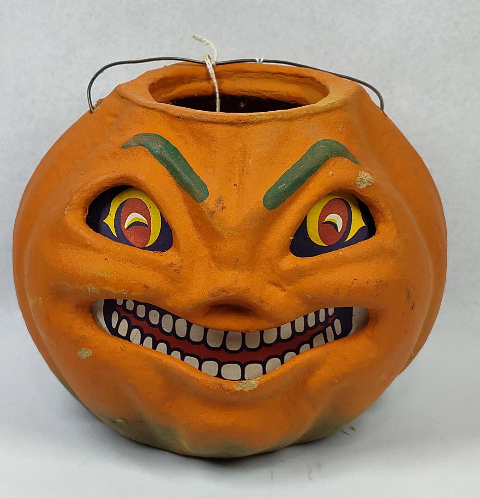 Seasons Gone By Jack-o-Lantern Bucket: 8x7x7 A molded Halloween bucket produced by Seasons Gone By, designed in a vintage folk-art style. The object is constructed from a composition material resembling papier-m?ch? or molded pulp. The