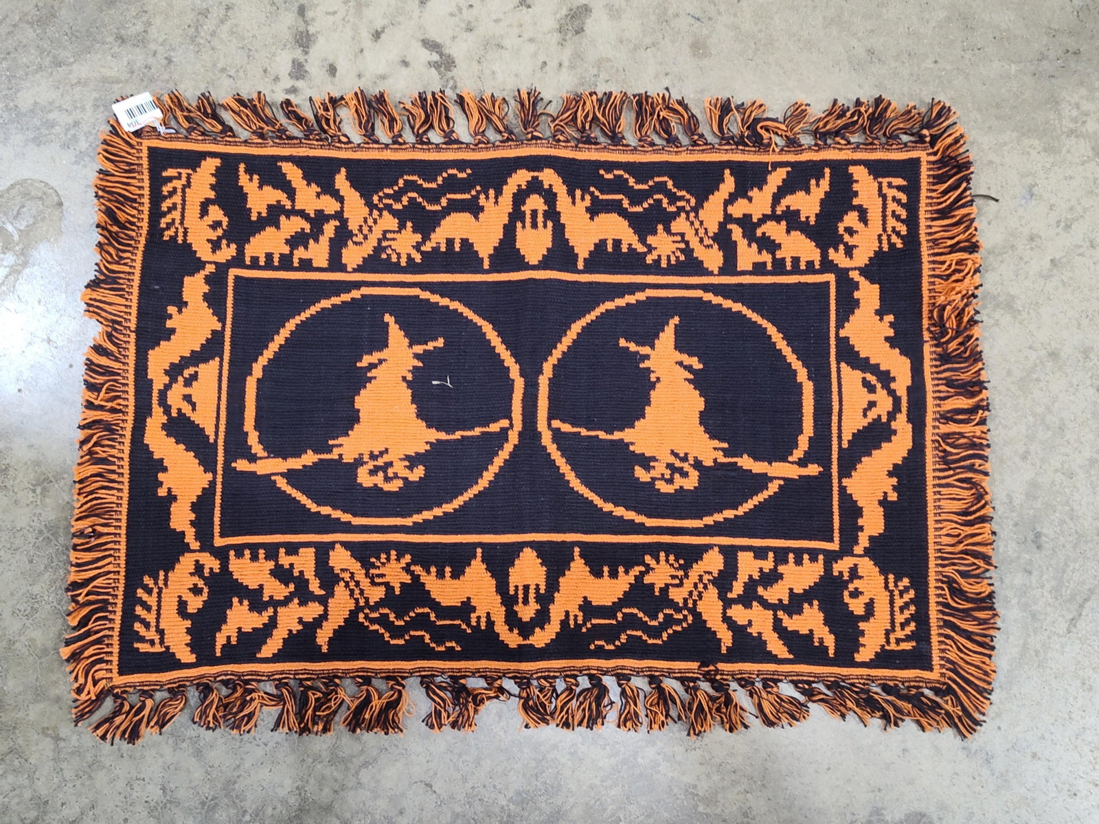 Halloween Flying Witch Tapestry Throw: 28x20 A rectangular woven jacquard textile featuring a seasonal Halloween design. The double-woven construction produces a reversible image in a classic orange and black color palette. The central