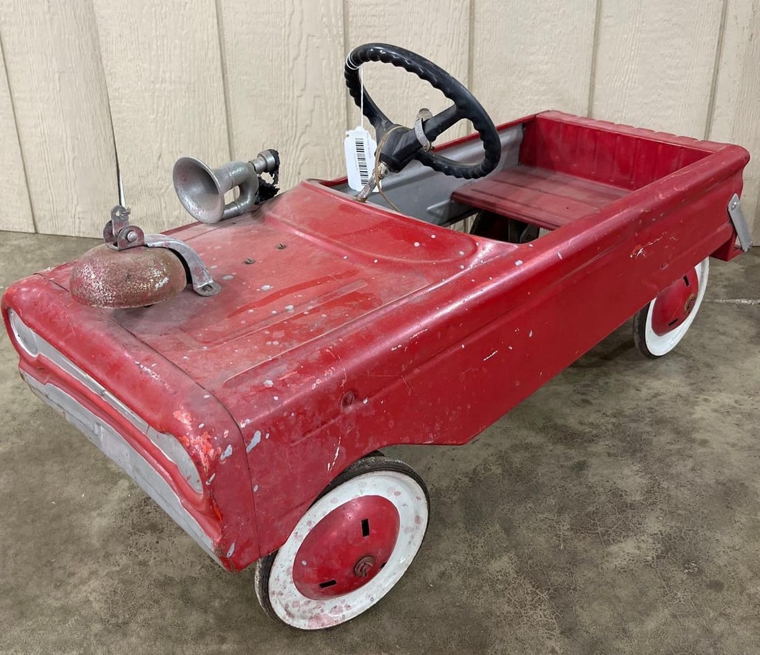 Murray Ohio Steel Fire Truck Pedal Car: 35 in long. A vintage pressed steel pedal car modeled as a fire truck with a pickup-style bed, attributed to the Murray Ohio Manufacturing Company. The vehicle features the characteristic flat-face fr