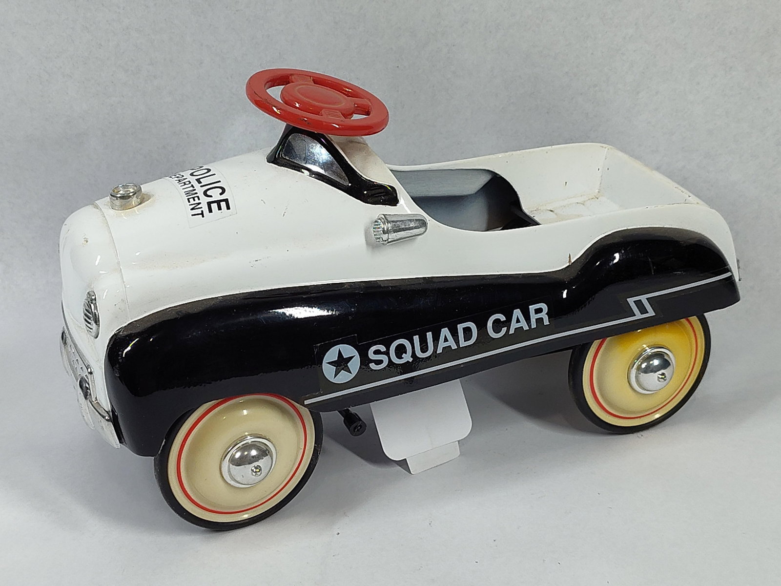 Xonex Police Chief Pedal Car No. 01089: 11 inches. A limited edition miniature replica pedal car produced by Xonex, identified as the Police Chief model. The toy is constructed with a painted pressed steel body and features chrome-finished