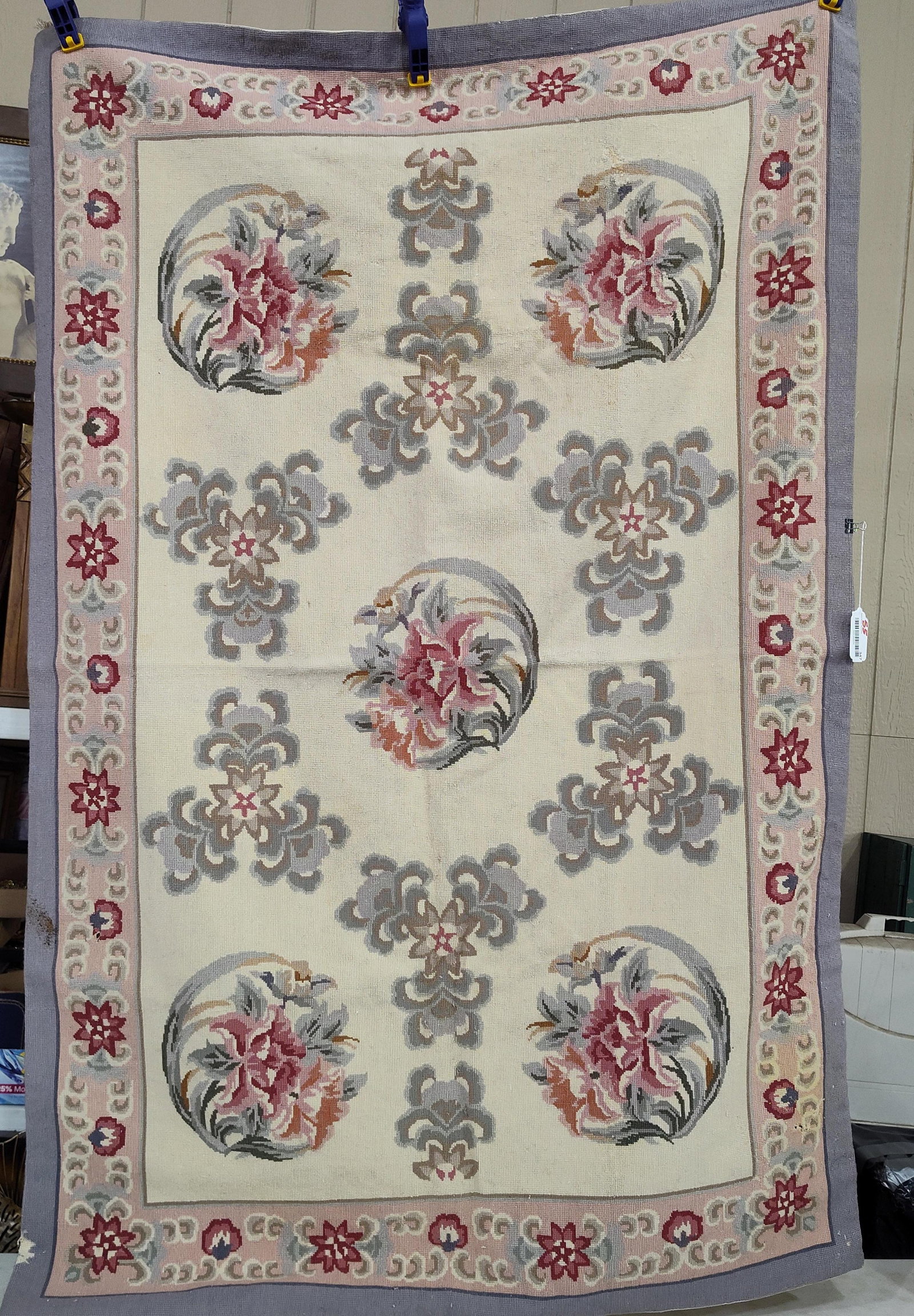 Aubusson Style Floral Needlepoint Rug: 44x68 in rug. This vintage needlepoint rug or wall hanging is worked in a traditional French Aubusson style. The design consists of a central circular medallion featuring pink and mauve roses with gra