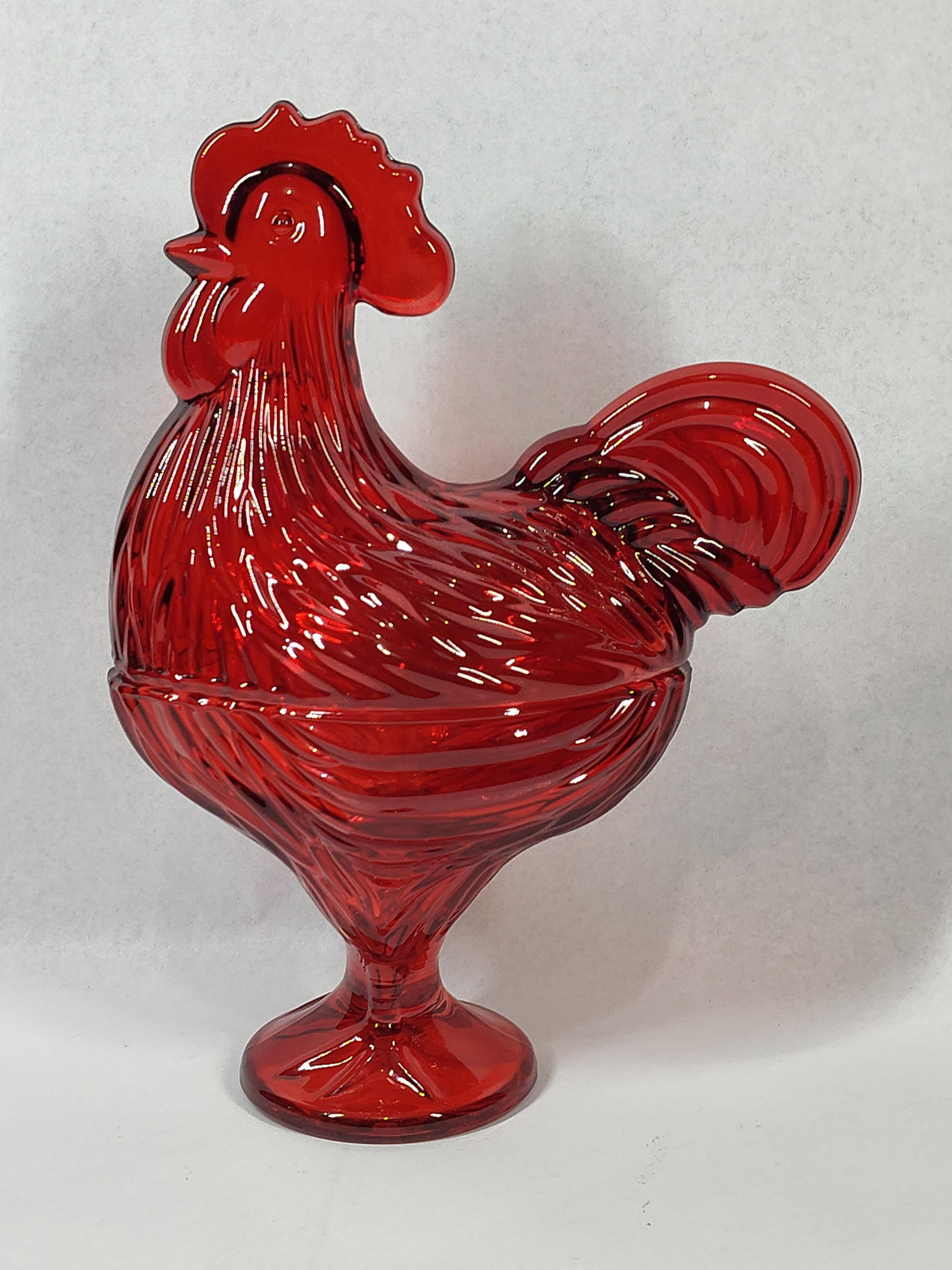Vtg Ruby Red Pressed Glass Rooster Dish: 11x9x5 This two-piece lidded pedestal dish is crafted in transparent ruby red pressed glass, shaped in the form of a rooster. The upper section serves as a lid, featuring a molded rooster head with a
