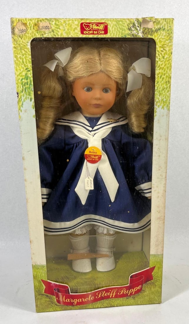Margarete Steiff Betina Sailor Doll Box: This collector doll is the Betina model manufactured by Margarete Steiff. The doll is constructed with vinyl limbs and head, featuring a blonde synthetic wig styled into pigtails secured with white fa