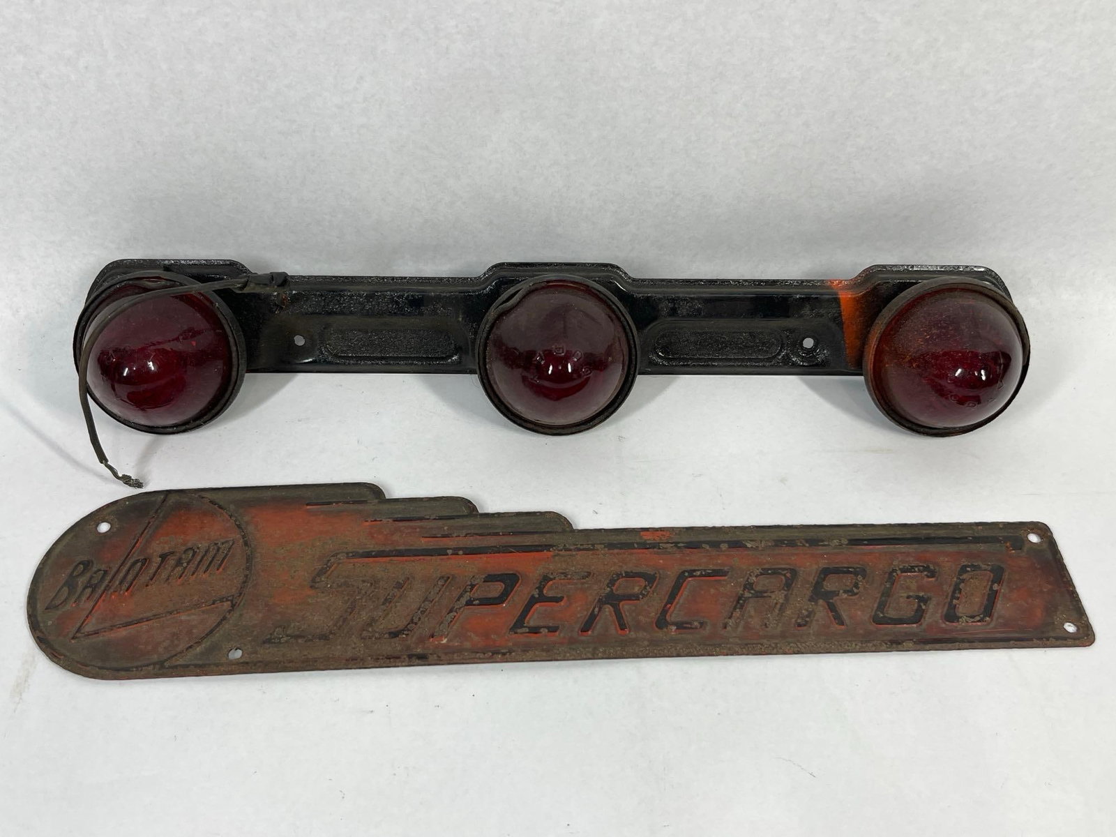 Bantam Supercargo Nameplate & Light Bar: This lot features two original pieces of commercial vehicle equipment associated with the American Bantam Car Company of Butler, Pennsylvania, dating to the mid-20th century. The first item is an