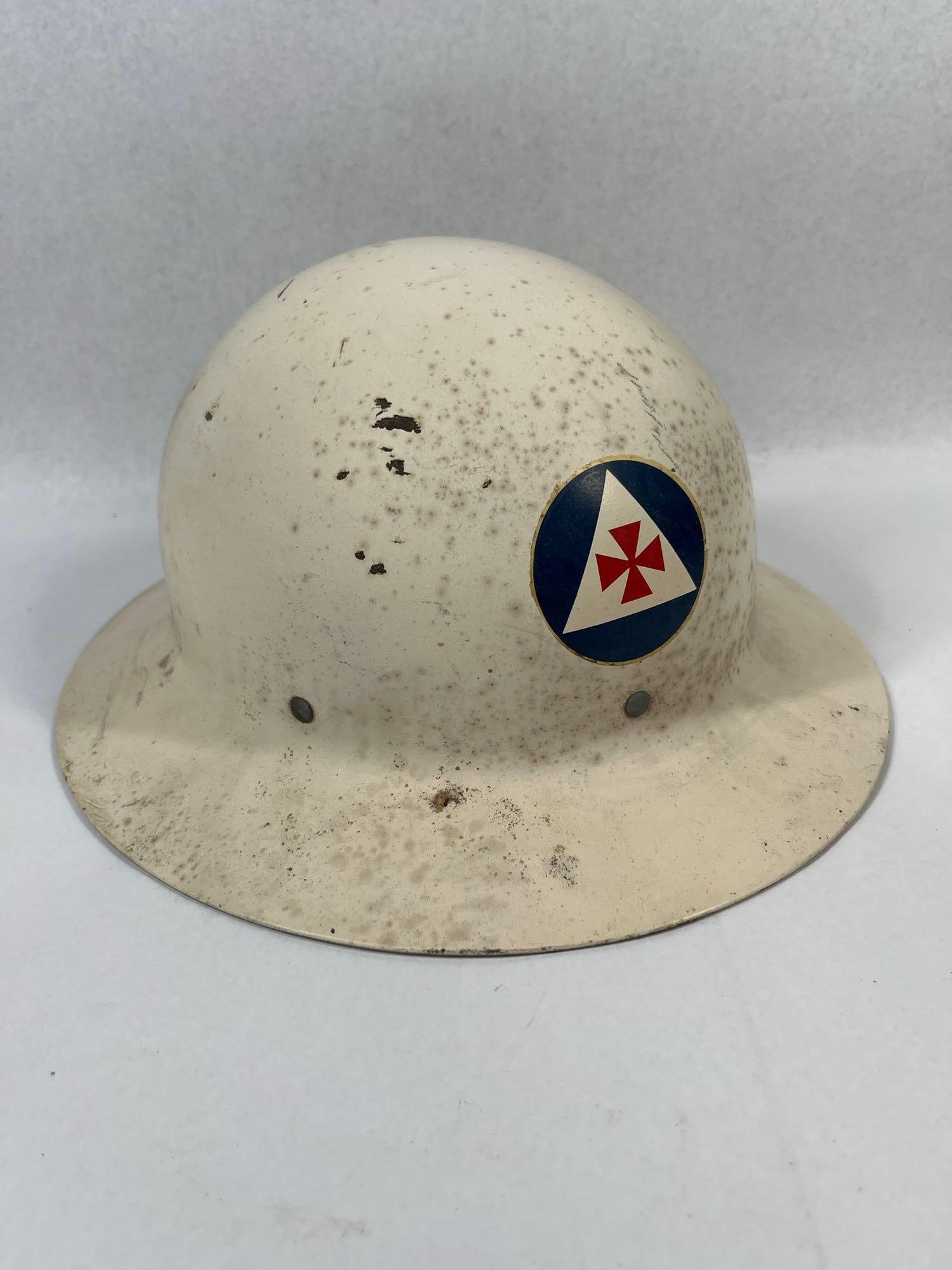 WWII OCD Medical Services Steel Helmet: A World War II era United States Office of Civilian Defense (OCD) steel helmet. The shell is based on the M1917A1 "Kelly" pattern and is finished in an original off-white or cream-colored