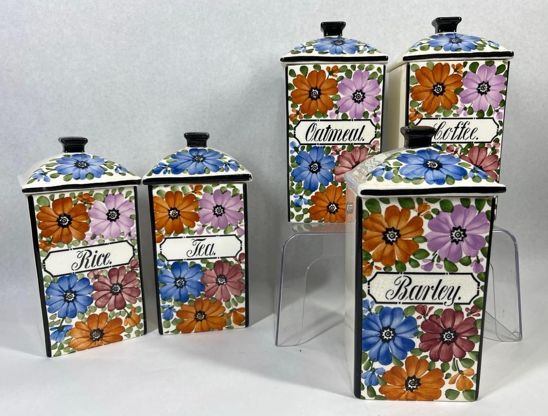Set German Floral Earthenware Canisters: 8 inches. A set of five graduated earthenware kitchen canisters with fitted pyramidal lids and square black-glazed knobs. Manufactured in Germany and imported by the George M. Thurnauer Company, Inc.