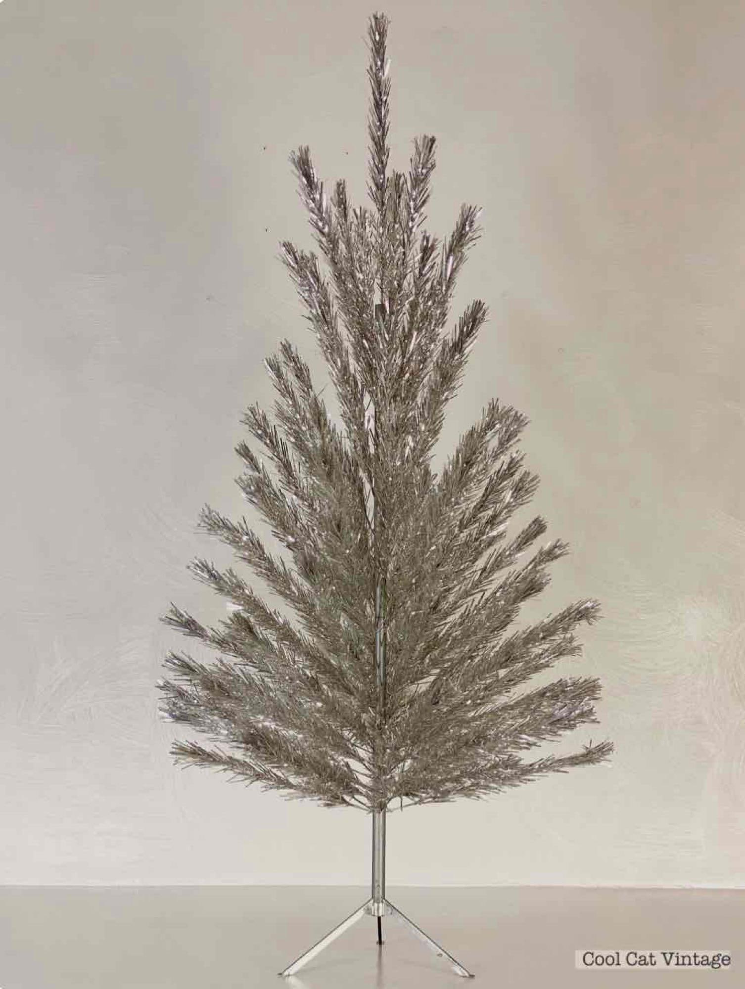 Silver Tree Co. Aluminum Christmas Tree: This vintage holiday item is an aluminum Christmas tree manufactured by the United States Silver Tree Co. of Scranton, Pennsylvania. The set comprises a central silver-toned metal pole, a folding