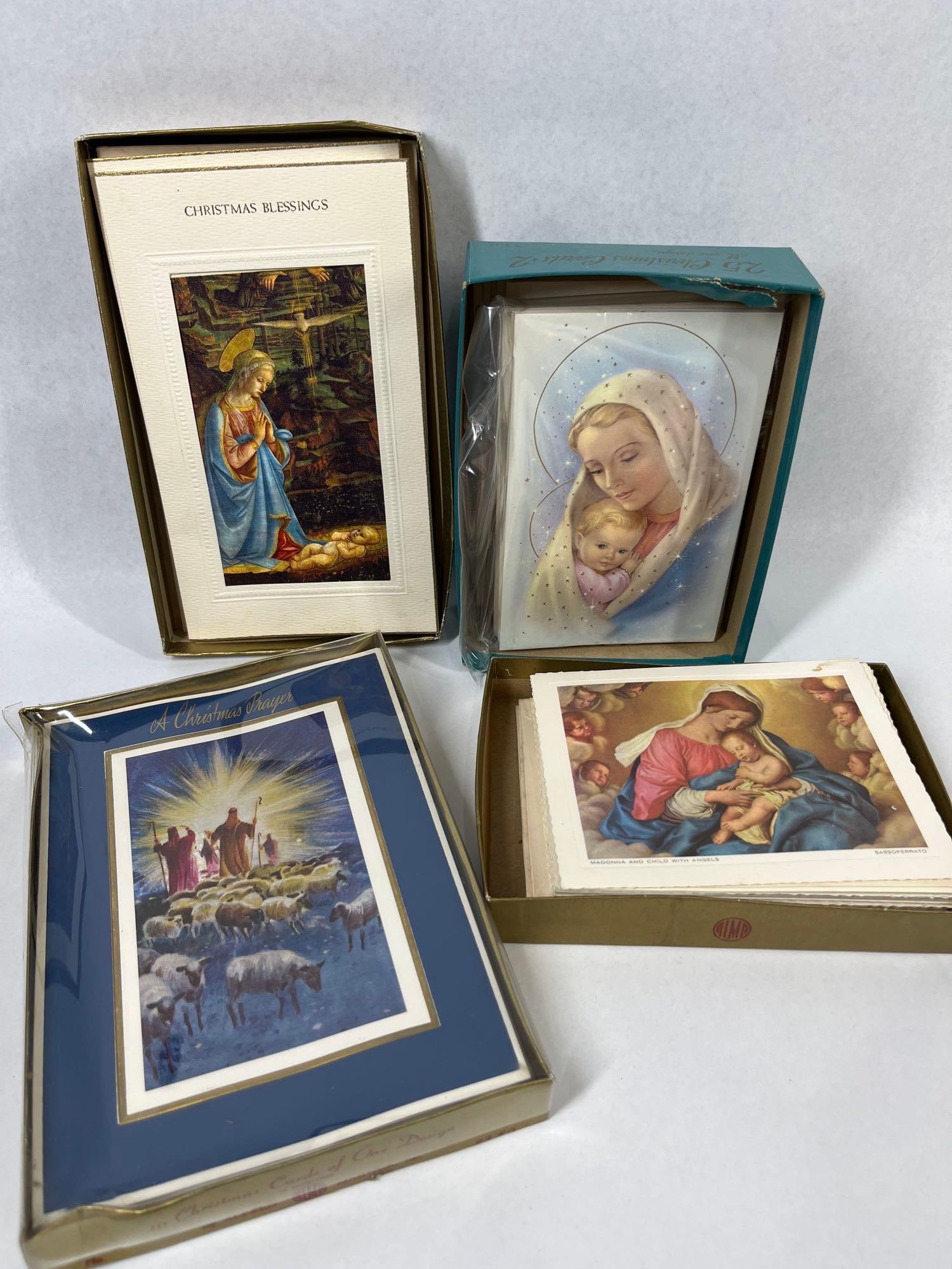 4 Boxes Vtg Religious Christmas Cards: This collection consists of four boxes of vintage religious Christmas greeting cards, produced circa the mid-20th century. The cards feature various Christian themes including the Nativity, the