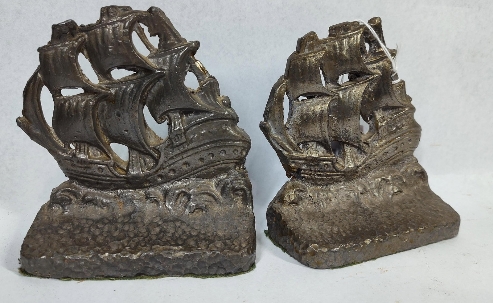 Verona Attrib. Cast Iron Ship Bookends: 5x2x5 A matching pair of vintage cast iron bookends, attributed to Verona and dating to the early to mid-20th century. Each bookend depicts a three-masted sailing ship or galleon with billowing