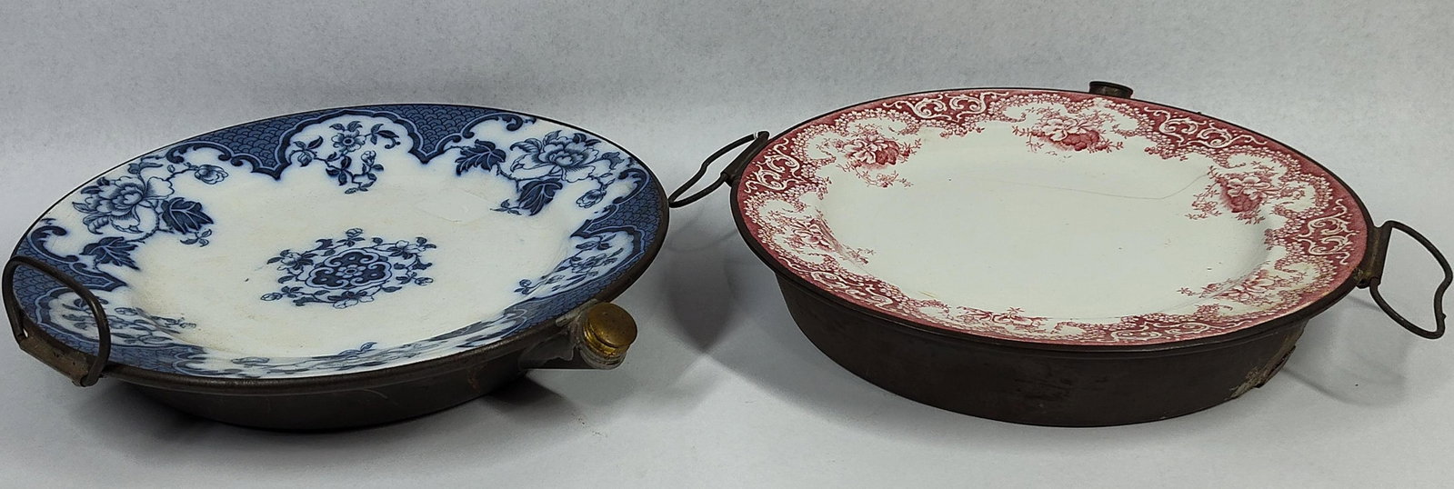 Pair Transferware Metal Warming Plates: 9.5 in diameter. This pair of antique hot water warming plates consists of ceramic plates set into deep metal bases. These utilitarian items were designed to be filled with hot water through a side