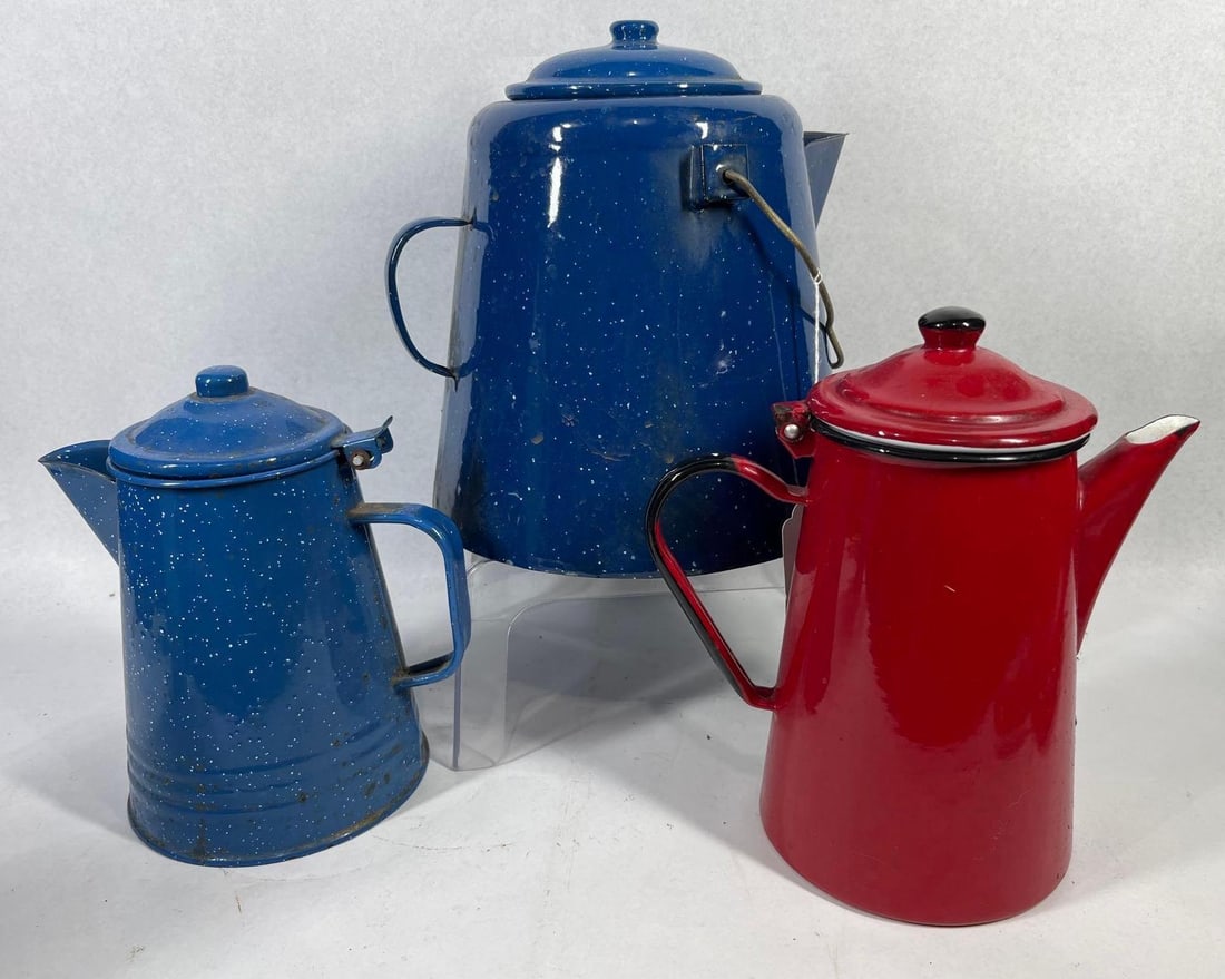 3 Vtg Enamelware Coffee Pots & Kettle: This collection consists of three vintage enameled metal vessels, including two blue-and-white speckled graniteware pieces and one solid red coffee pot. The largest vessel is a tapered blue kettle