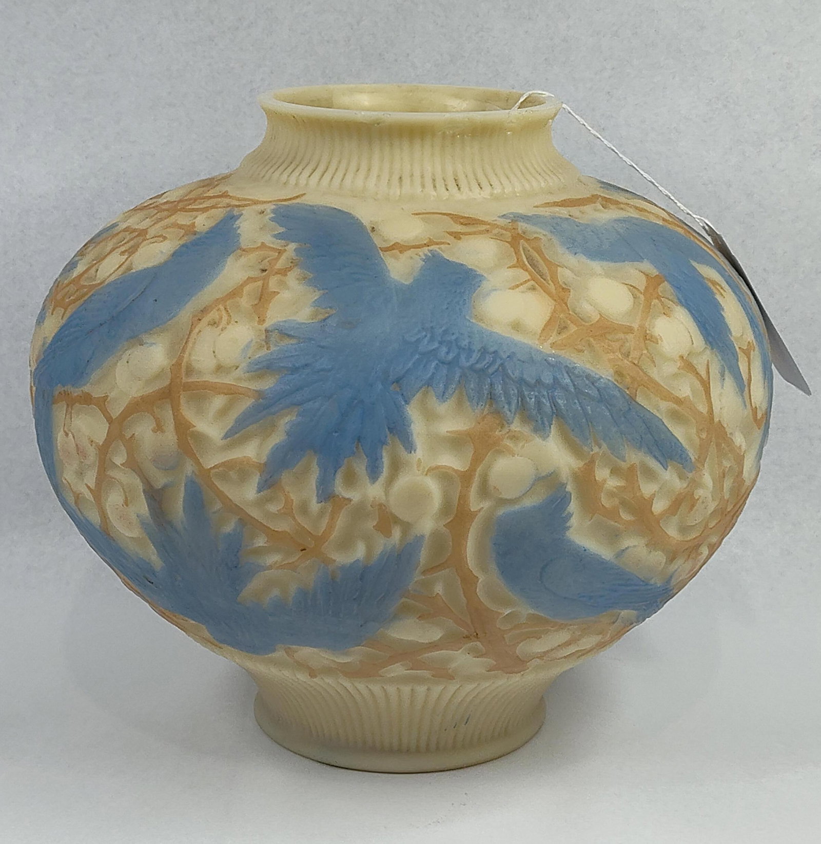 Phoenix/Consolidated Bird Relief Vase: 9x10. This art glass vase, attributed to the Consolidated Lamp and Glass Company or the Phoenix Glass Company, features the Blue Jay pattern in high-relief. The vessel is designed with a squat,