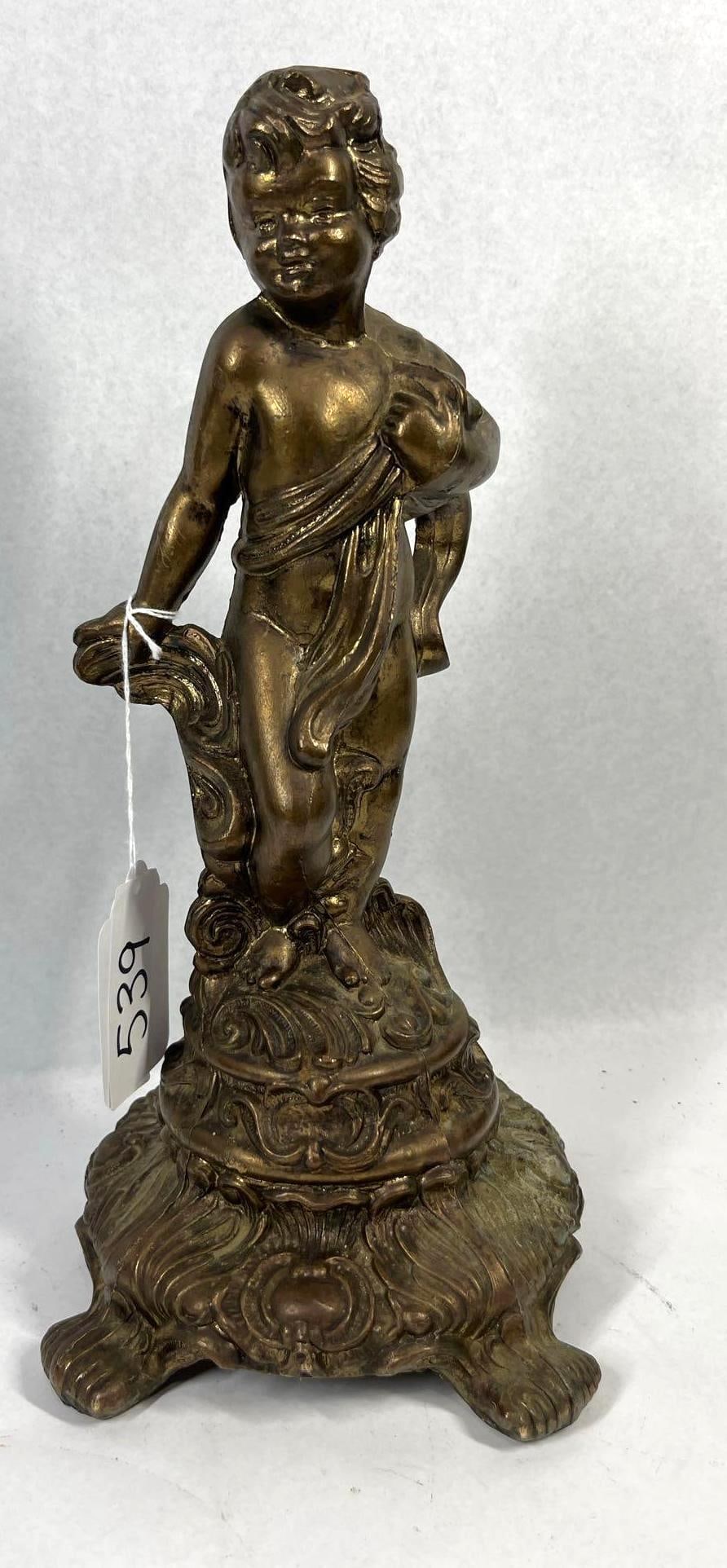 Rococo Revival Gilt Metal Putto Base: 14 inches. This cast metal sculpture, likely spelter with a gilt bronze-tone patina, depicts a standing putto or cherub figure in a classical pose. The figure is partially draped in a flowing cloth