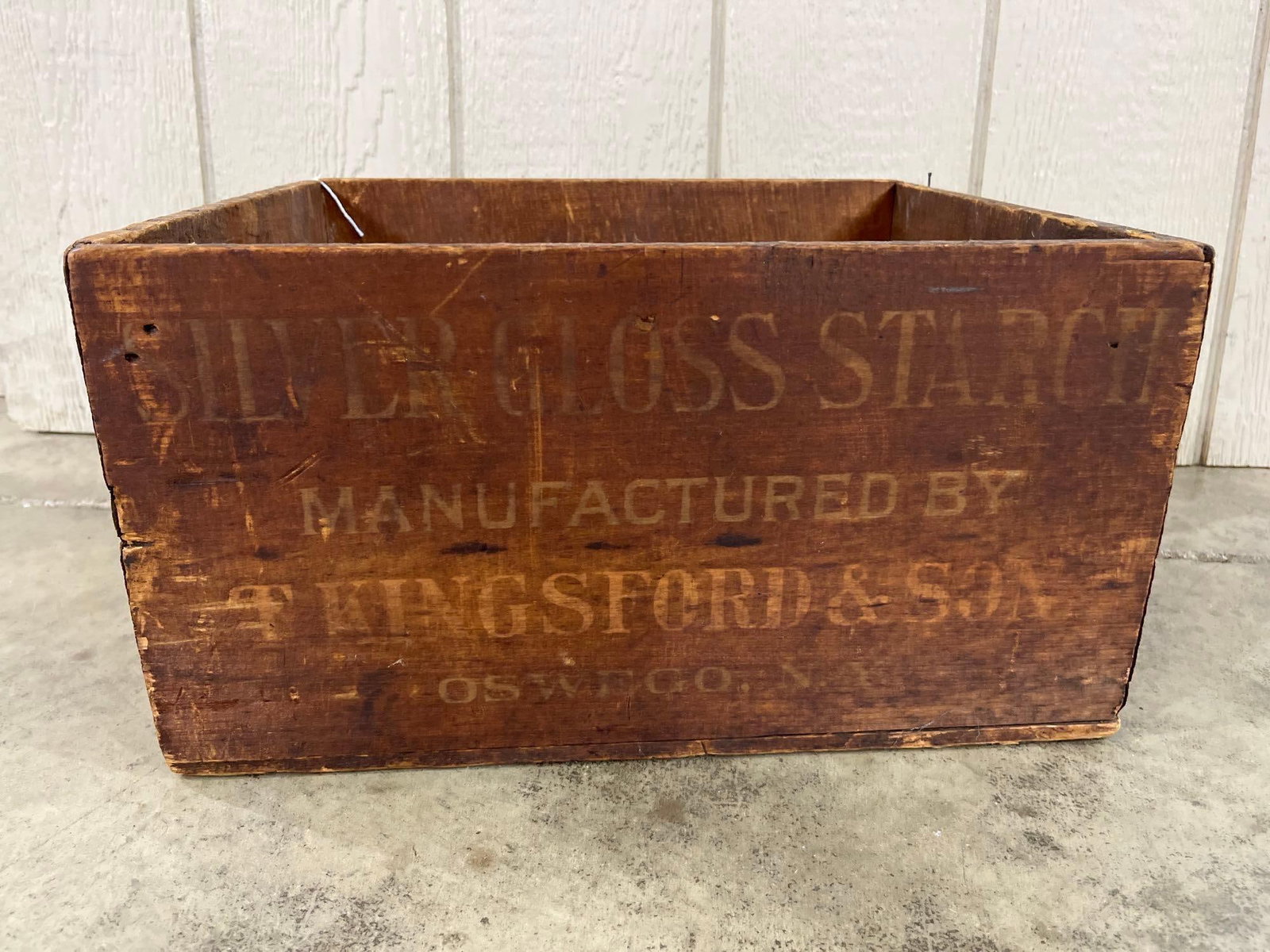Kingsford's Silver Gloss Starch Crate: 16x14x9 This is an antique wooden shipping crate featuring original stenciled advertising for Kingsford's Silver Gloss Starch. The crate is constructed from solid wood panels secured with iron