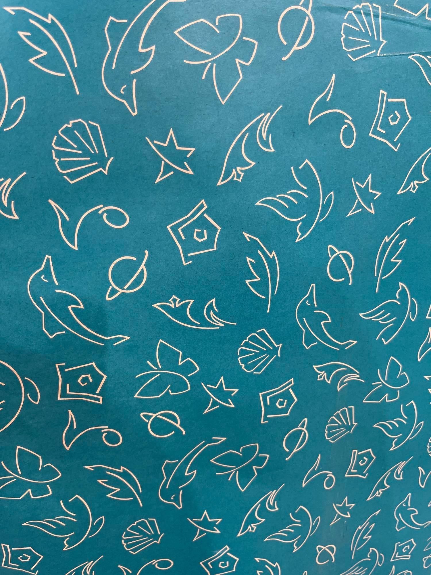 Bonita Pioneer Teal Motif Wrap Roll/Box: A large commercial roll of teal gift wrap featuring white line-art dolphins, shells, and planets, measuring 30 inches wide by 833 feet long, in its original Bonita Pioneer shipping box.