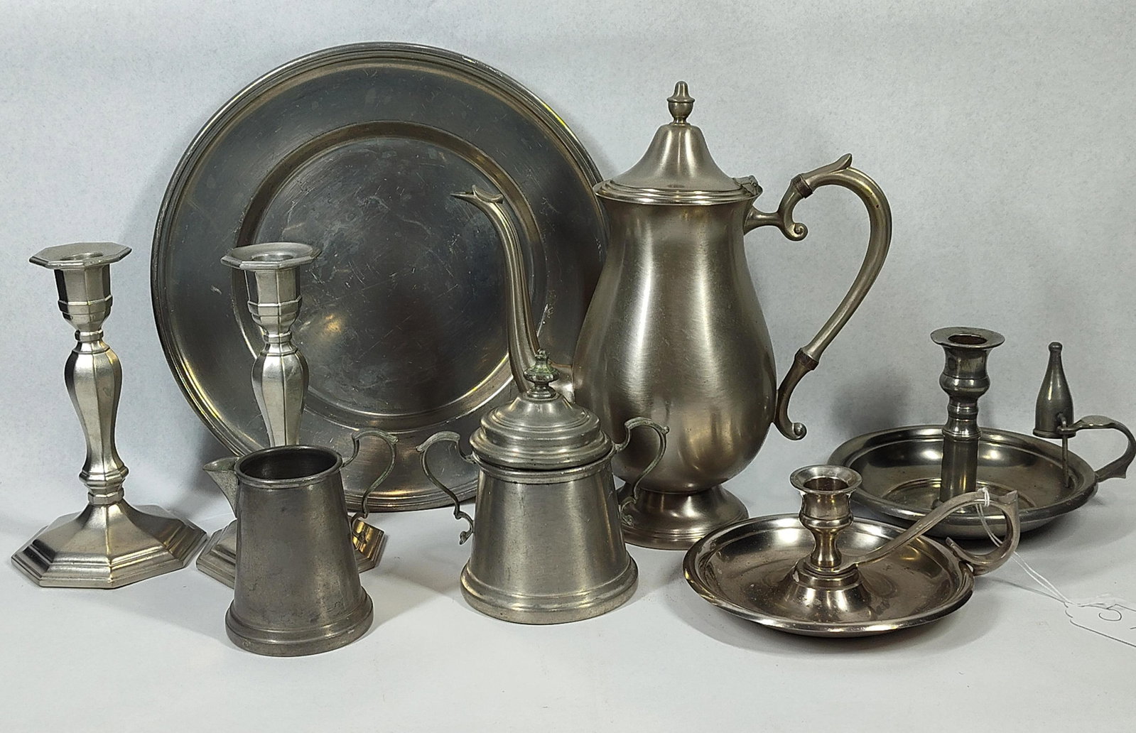 Gorham & International Pewter Set 9: Plate does not have any markings. This nine-piece collection of American pewter consists of items primarily in the Colonial Revival style from several notable 20th-century makers. The group includes a