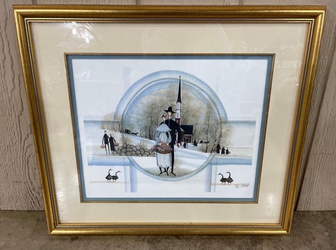 Buckley Moss Winter Church Lithograph: 24x21 A limited edition offset lithograph by P. Buckley Moss (American, b. 1933), featuring a characteristic folk art winter scene. The central composition, framed within a circular border, depicts a 