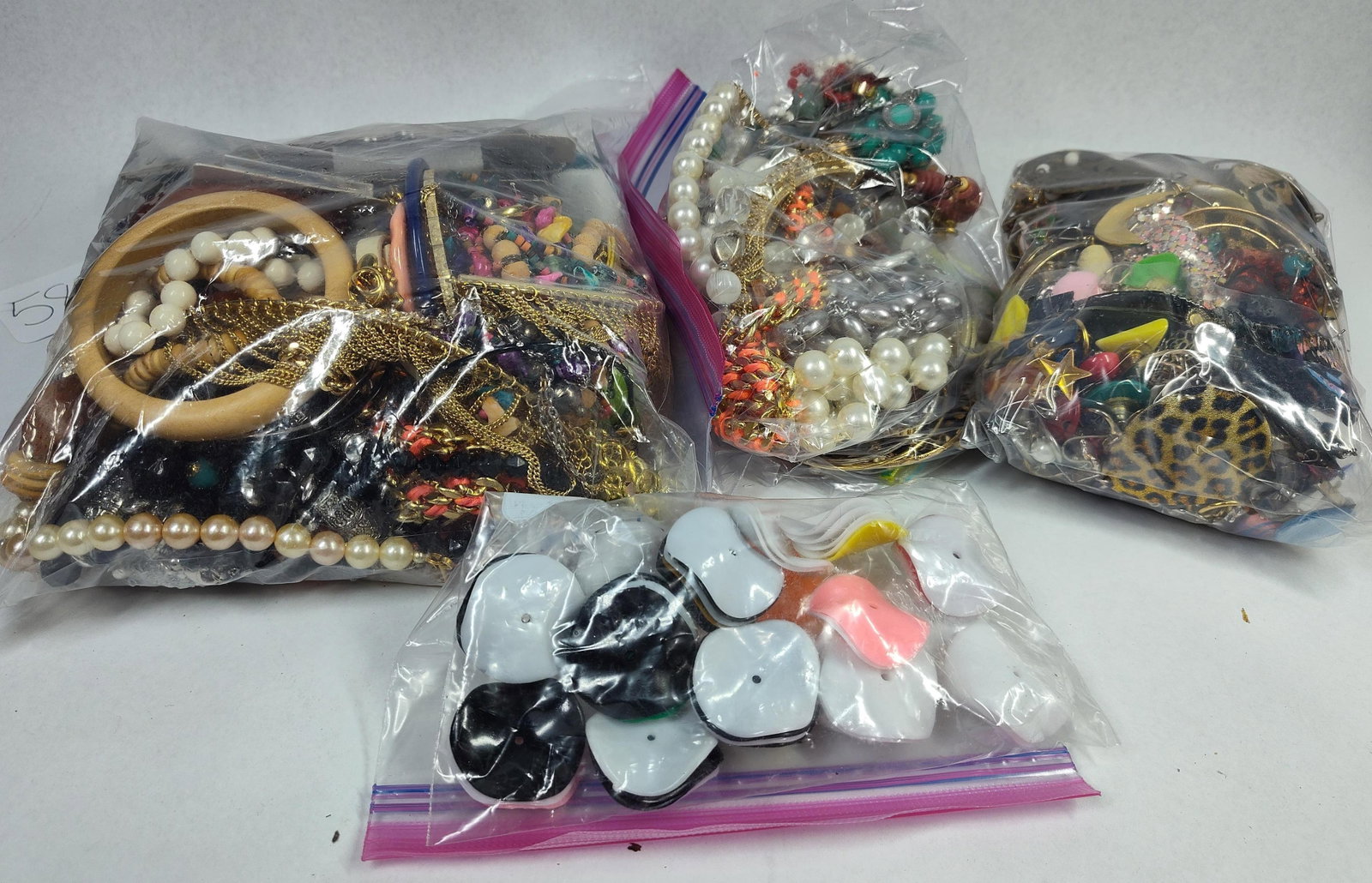 Vtg & Contemporary Costume Jewelry: This collection consists of approximately 5 bags of assorted costume jewelry including an array of necklaces, bracelets, bangles, and earrings. The lot features a variety of styles ranging from