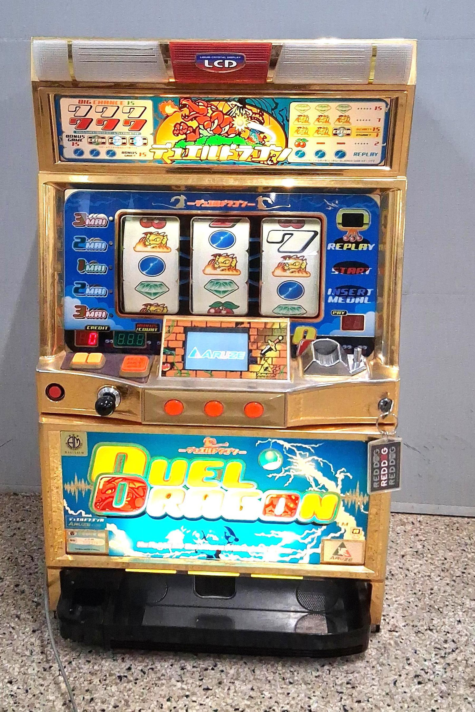 Aruze Corp. Duel Dragon R Pachislo Slot: In great working condition This Japanese pachislo slot machine is manufactured by Aruze Corp. and titled Duel Dragon R. It is an electronic three-reel system featuring a skill-stop mechanism that