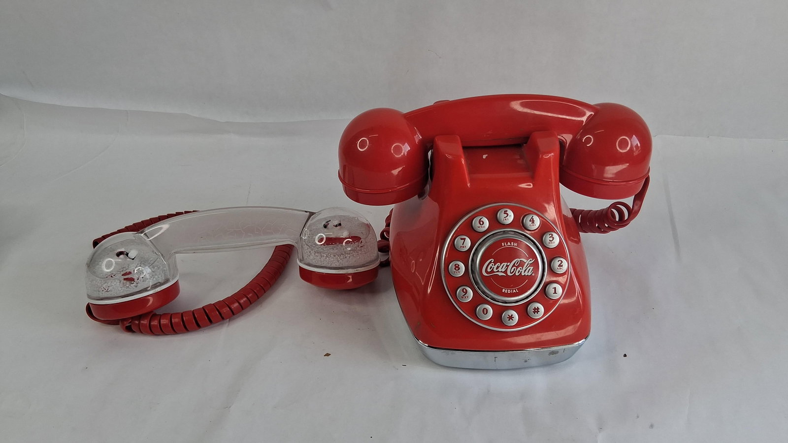Polyconcept Coca-Cola Snow Dome Phone: This Coca-Cola Snow Dome Phone, Art. no. 841.058, was produced in 2001 by Polyconcept USA Inc. under license from The Coca-Cola Company. The novelty landline telephone features a red plastic housing