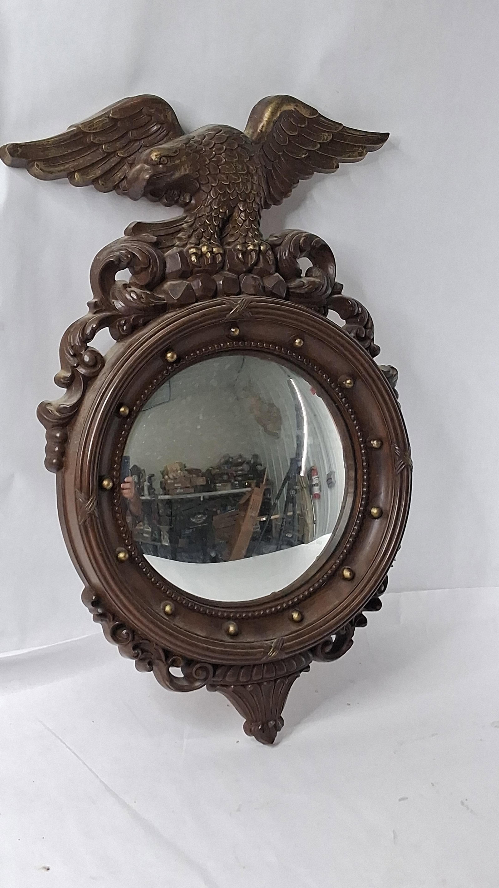 Dart Industries Eagle Convex Mirror: 11x11x28 This mid-20th-century convex wall mirror is executed in the Federal Revival style by Dart Industries. The frame is constructed from a molded composite material with a dark bronze-toned