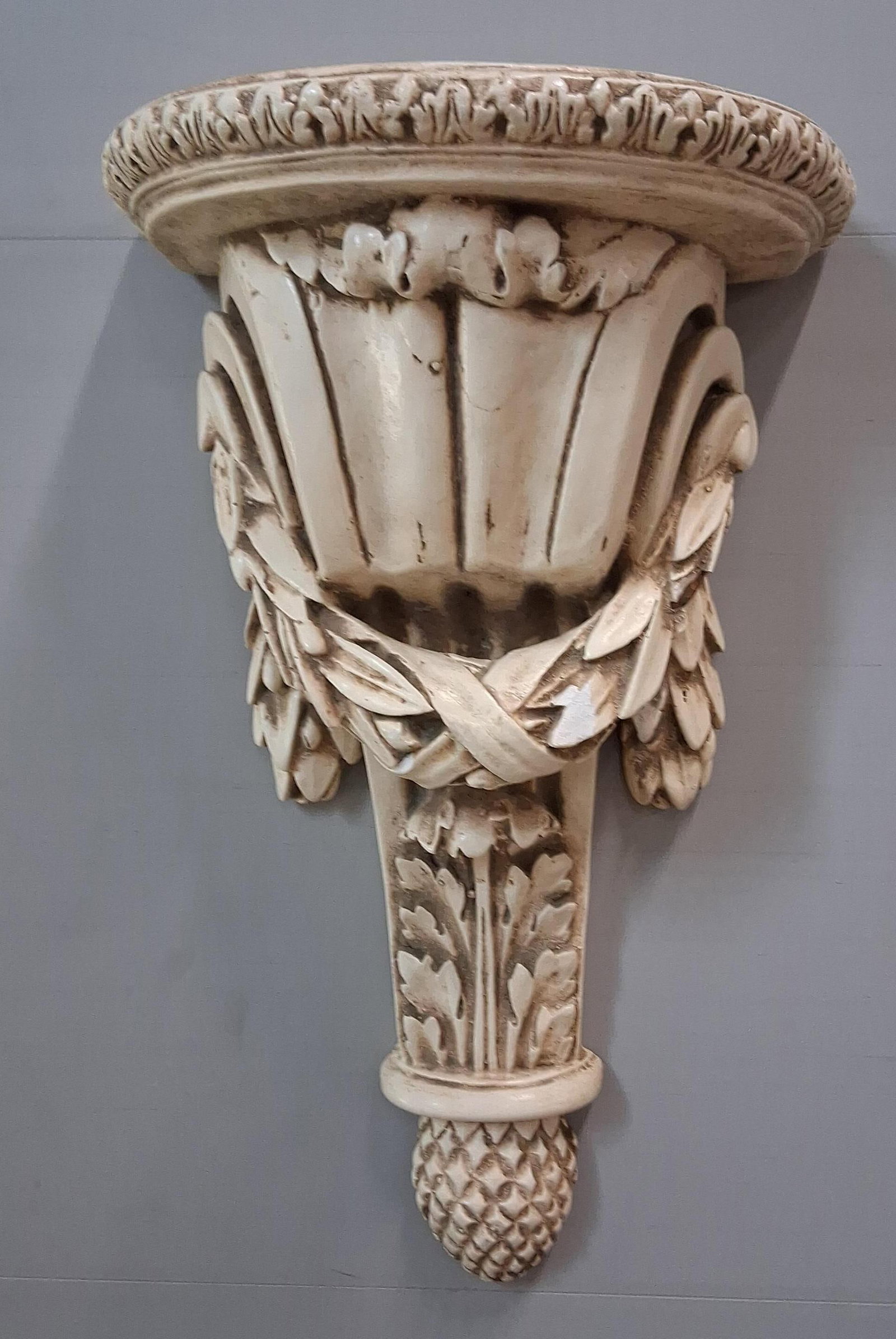 Neoclassical Wall Bracket w/ Pineapple: 10x16 A Neoclassical style decorative wall bracket, designed for use as a wall-mounted shelf or corbel. The piece features a semicircular D-shaped top with a molded edge decorated in a leaf-and-dart