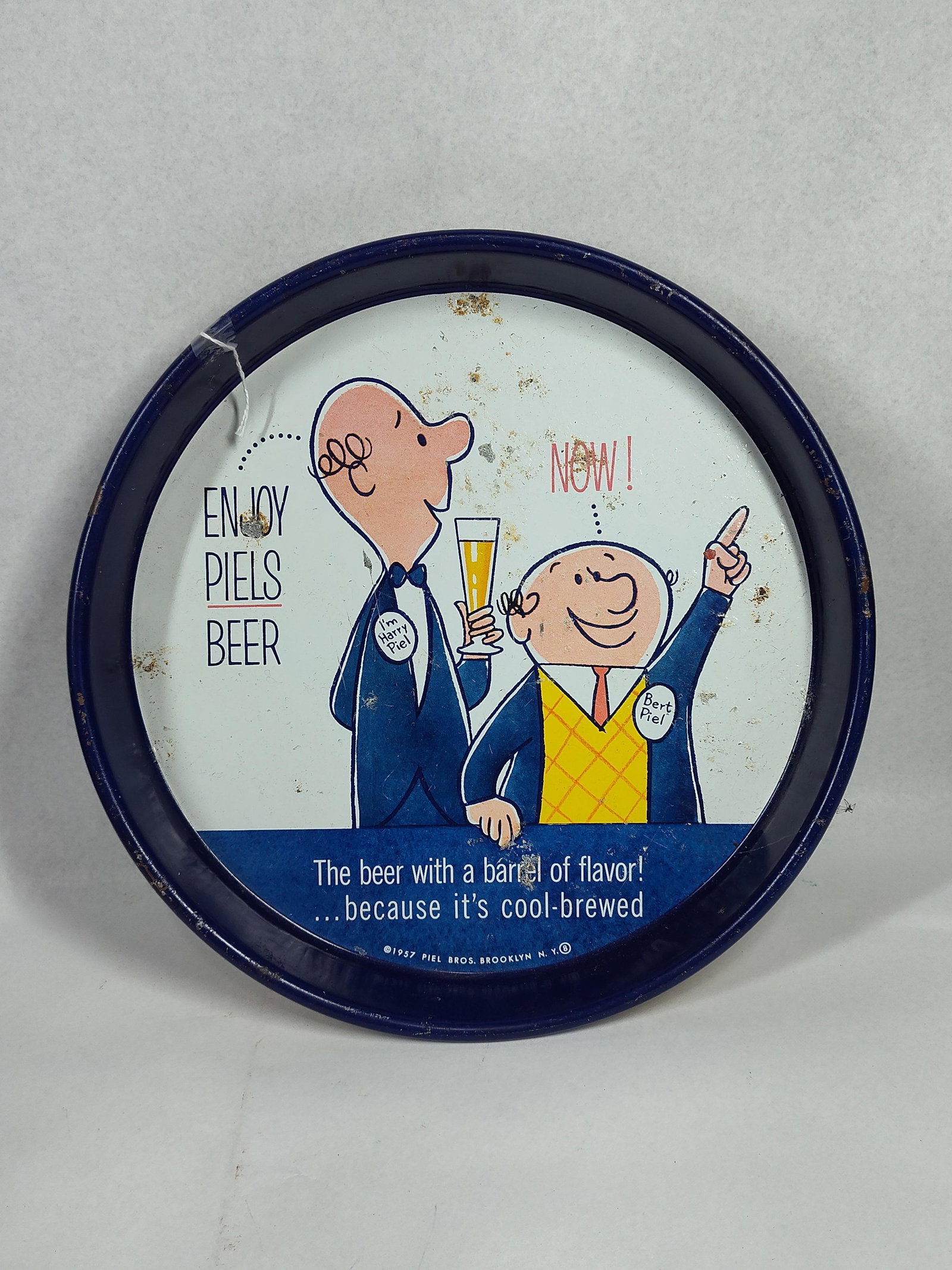 1957 Piels Light Beer Bert & Harry Tray: 13x1.5 This circular advertising tray for Piel Bros. of Brooklyn, New York, is constructed of lithographed tin and dates to 1957. The tray features the popular animated mascots Bert and Harry Piel,