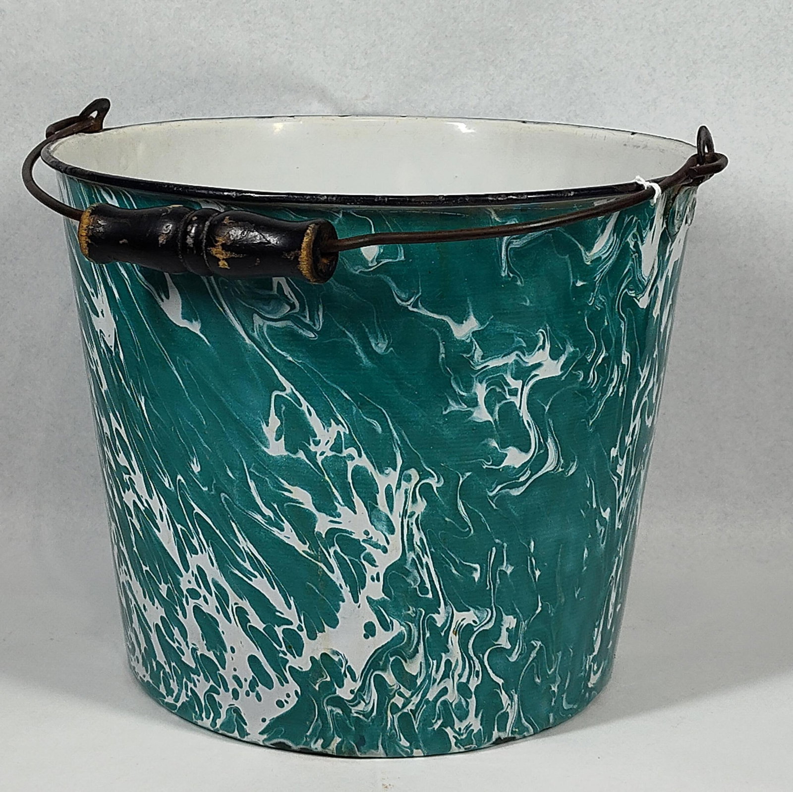 Green & White Swirl Graniteware Bucket: 9.5x12 An antique graniteware bucket featuring a distinctive marbled green and white enamel finish, commonly referred to as swirl or agateware. The vessel is constructed of pressed steel or iron with