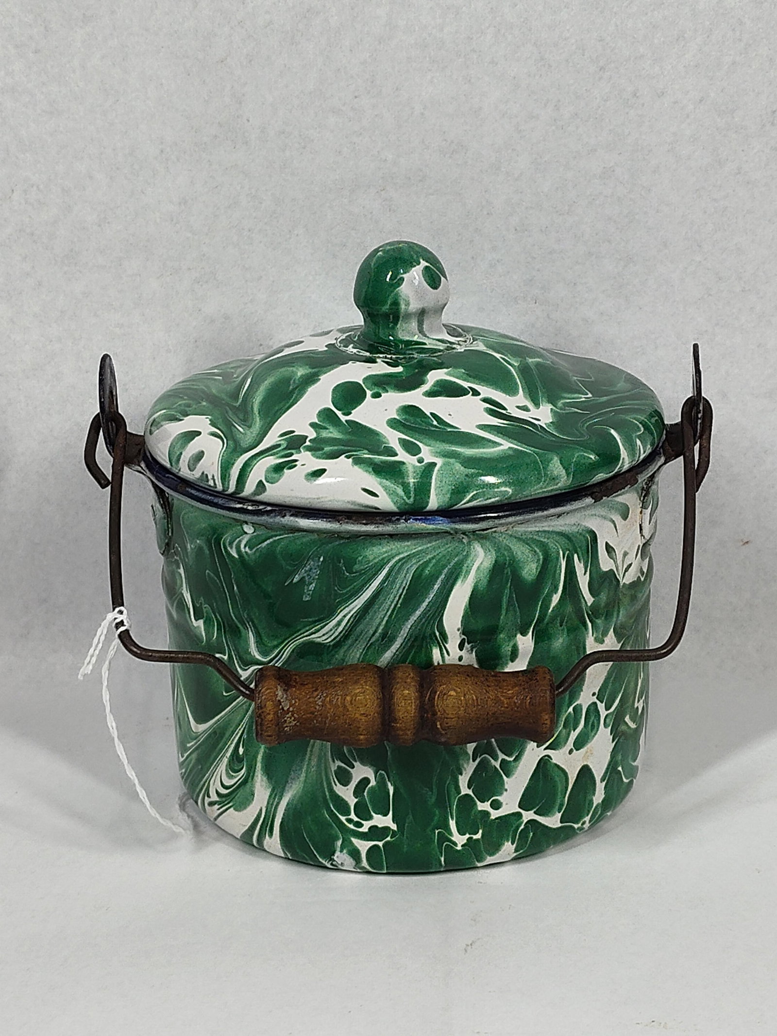 Green & White Swirl Graniteware Set: Two pieces of green and white swirl graniteware enamelware. The collection includes one cylindrical bucket with a matching lid and one shallow round dish. Each piece is crafted from vitreous enamel