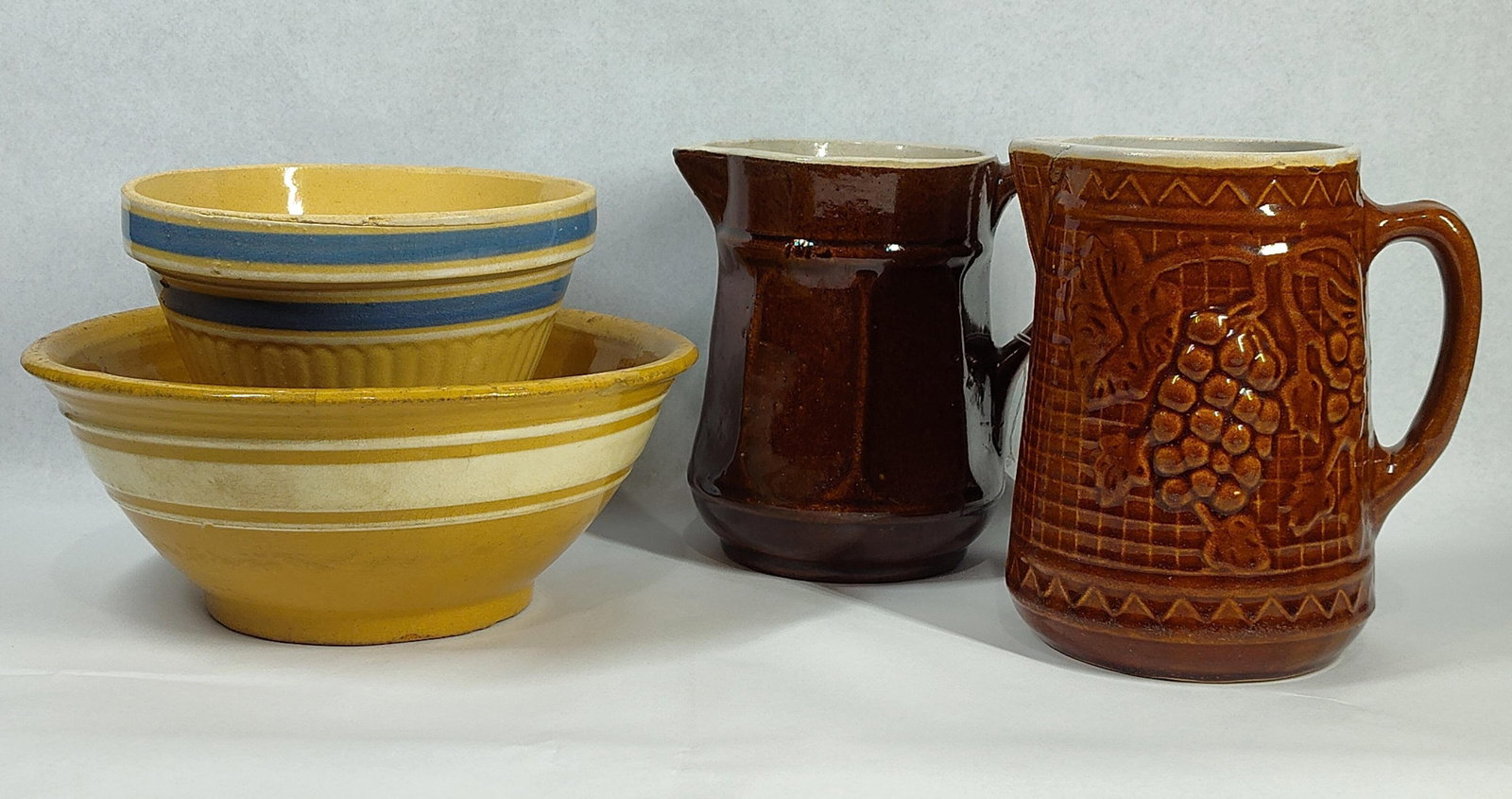 Ransbottom Yellow & Stoneware Pitchers: Bowls are 7.5 and 10.5. Pitchers are 7 and 8 inches tall. This collection features utility ceramics manufactured by the Robinson Ransbottom Pottery Company of Roseville, Ohio. The group includes two