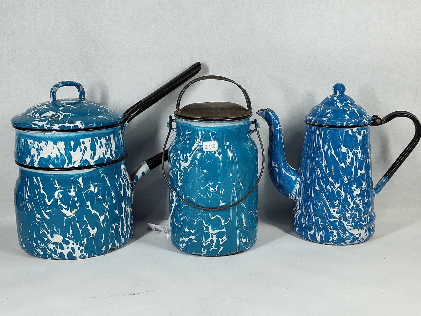 Trio Blue Mottled Agate Enamelware: This lot features three pieces of blue and white mottled enamelware, also known as agateware or graniteware. The items are constructed from steel with a fused porcelain enamel coating. The set
