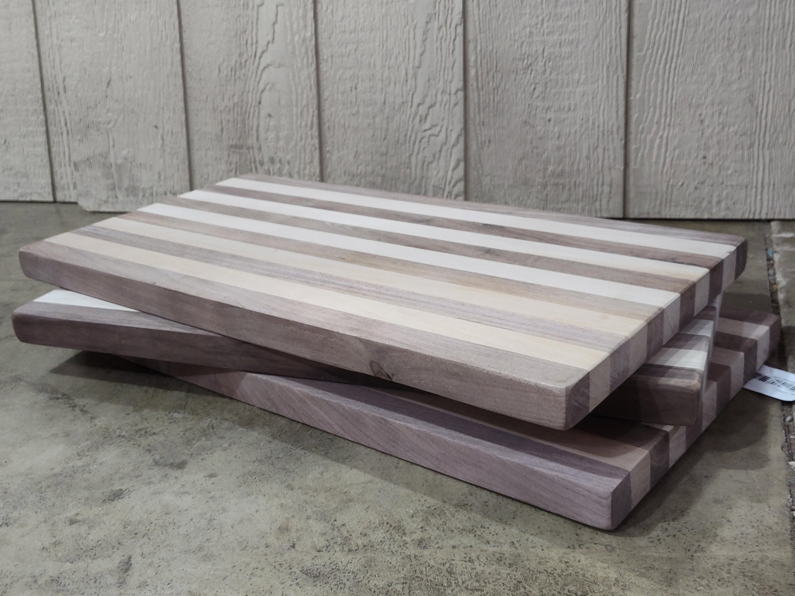 Trio Maple & Walnut Edge-Grain Boards: 24x12 each. A set of three handcrafted hardwood cutting or charcuterie boards. Each rectangular board features an edge-grain construction with a repeating striped pattern composed of alternating