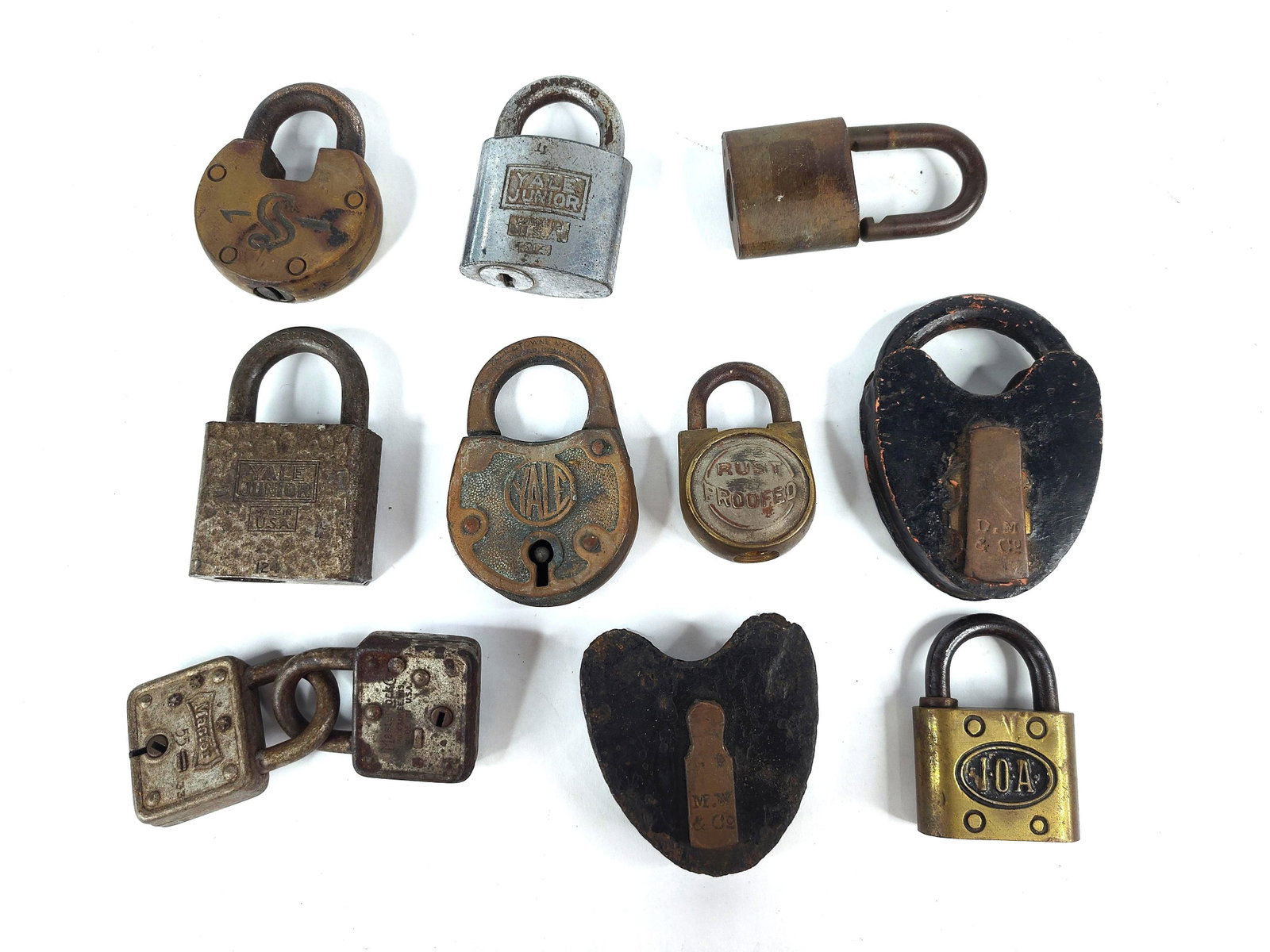 11 Yale Master & Heart Shaped Padlocks: A collection of 11 and antique padlocks of American manufacture, dating from the late 19th through the mid-20th century. The assortment is constructed from cast iron, stamped steel, and solid brass,