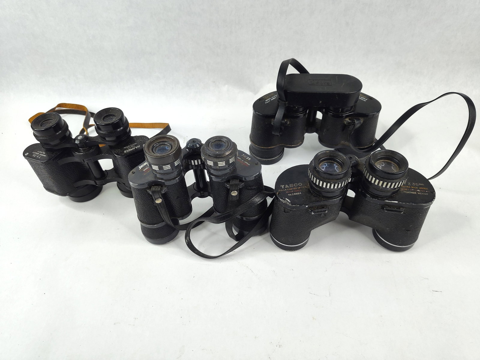 Tasco, Jason, Sears & Harpers Binocular: This lot features four Porro prism binoculars, all in the 7x35mm format, primarily manufactured in Japan for the American market. The collection includes wide-angle and standard field-of-view models c