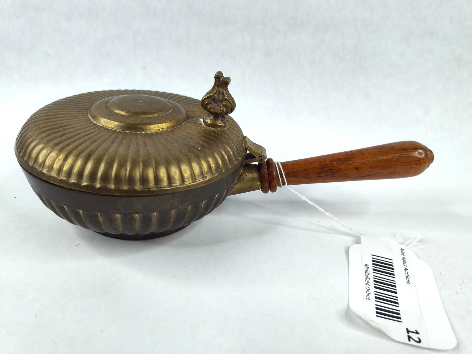 Gadrooned Brass & Wood Silent Butler: This silent butler, or crumb catcher, is constructed from cast brass with a gadrooned or ribbed pattern featured on both the bowl and the hinged lid. The lid is topped with an ornate cast finial. The 