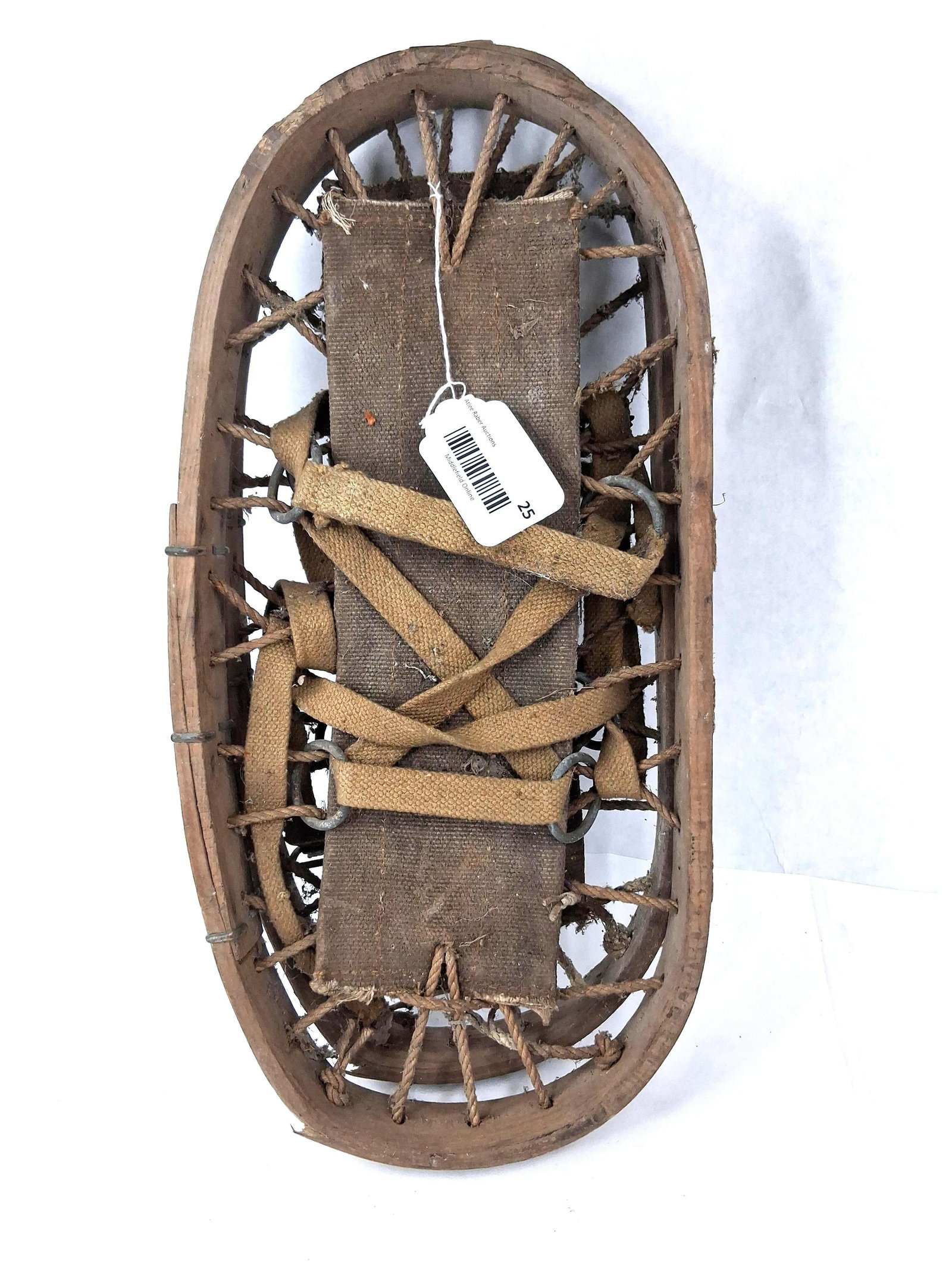 Pair WWII Canadian Bearpaw Snowshoes: This is a pair of bearpaw-style snowshoes of Canadian manufacture, consistent with mid-20th century military issue equipment. Each snowshoe features a steam-bent wooden frame, typically ash, secured
