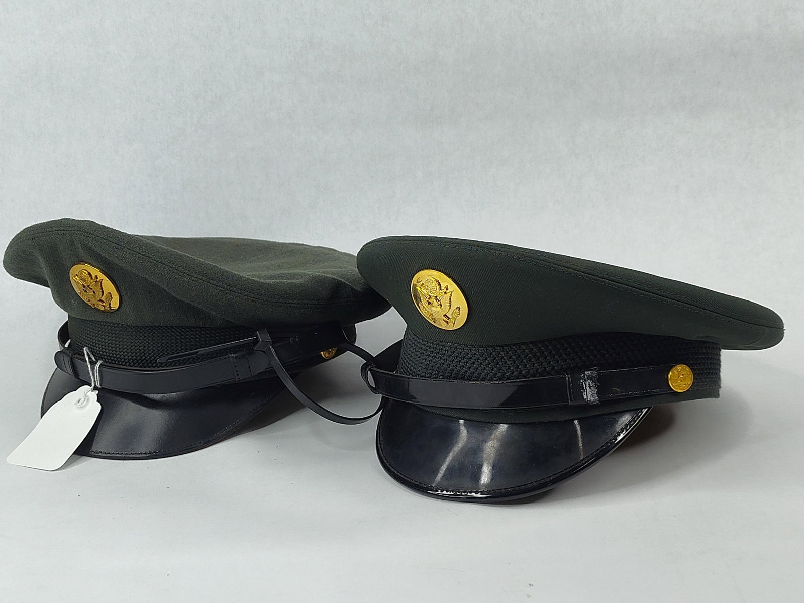 Pair US Army Vietnam Service Caps AG-44: A pair of United States Army enlisted or non-commissioned officer peaked service caps, commonly referred to as barracks covers. These examples are representative of the Cold War and Vietnam War era,