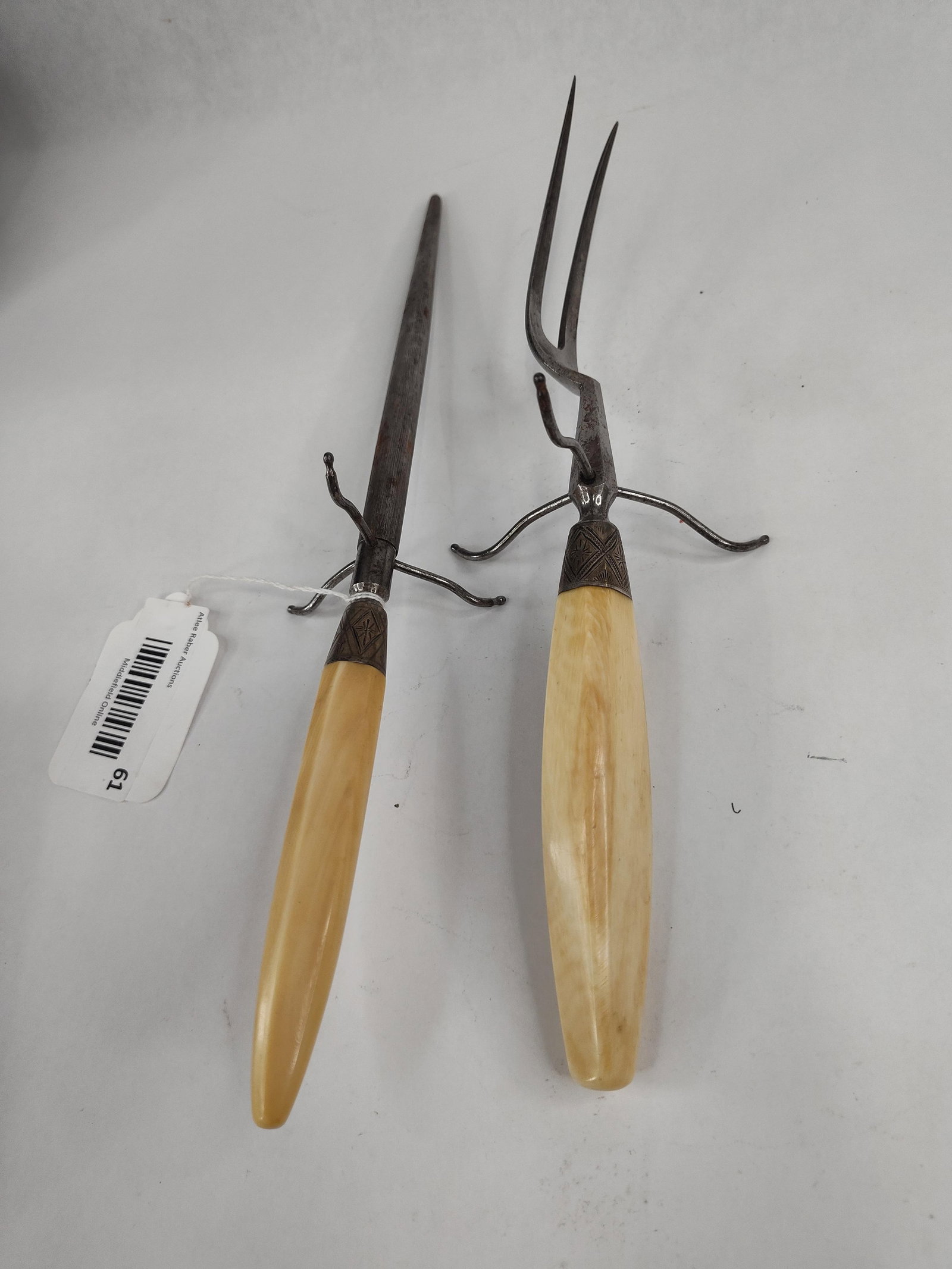 Will & Finck Ivory Carving Fork & Steel: This two-piece carving set was manufactured by the prominent San Francisco firm Will & Finck. The set includes a traditional two-tine meat fork and a tapered sharpening steel rod with fine