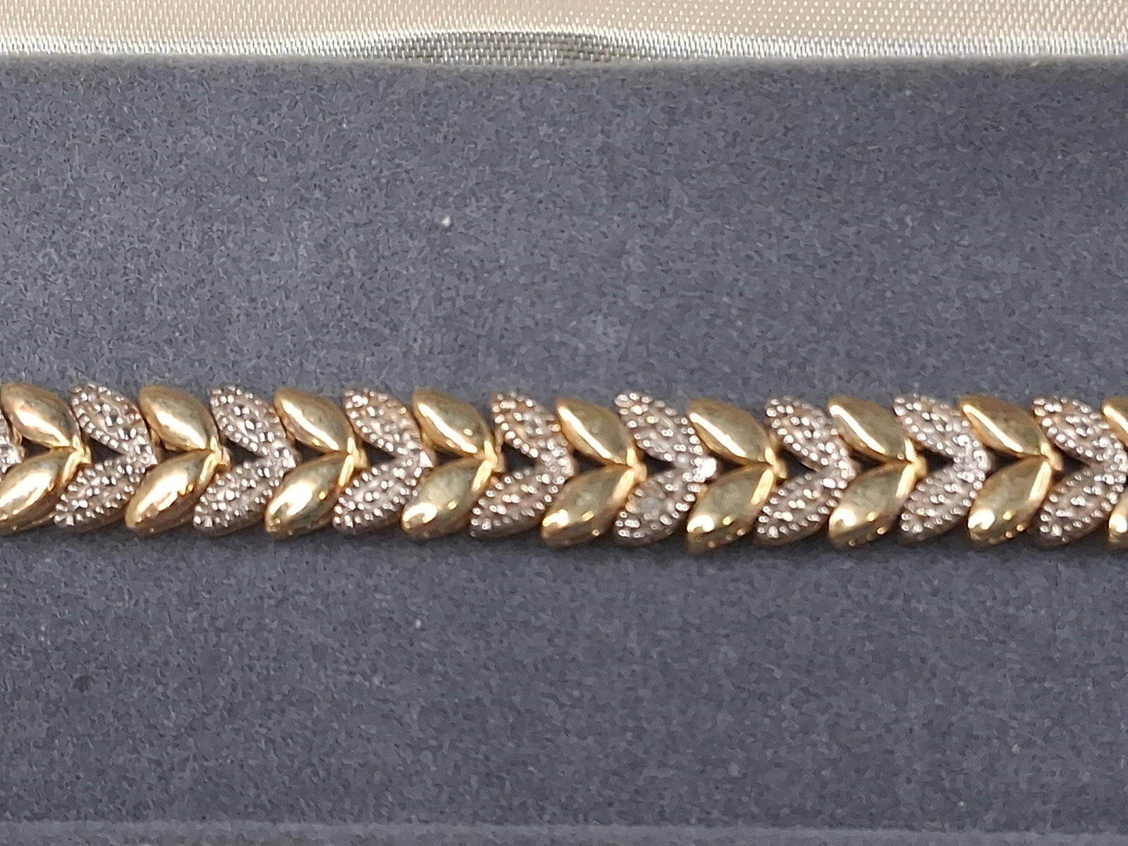 FAS Str. Gold Vermeil Leaf Bracelet: A yellow gold plated sterling silver bracelet by FAS featuring an articulated series of repeating chevron-shaped leaf links. The design alternates between pairs of polished yellow-tone leaf motifs and