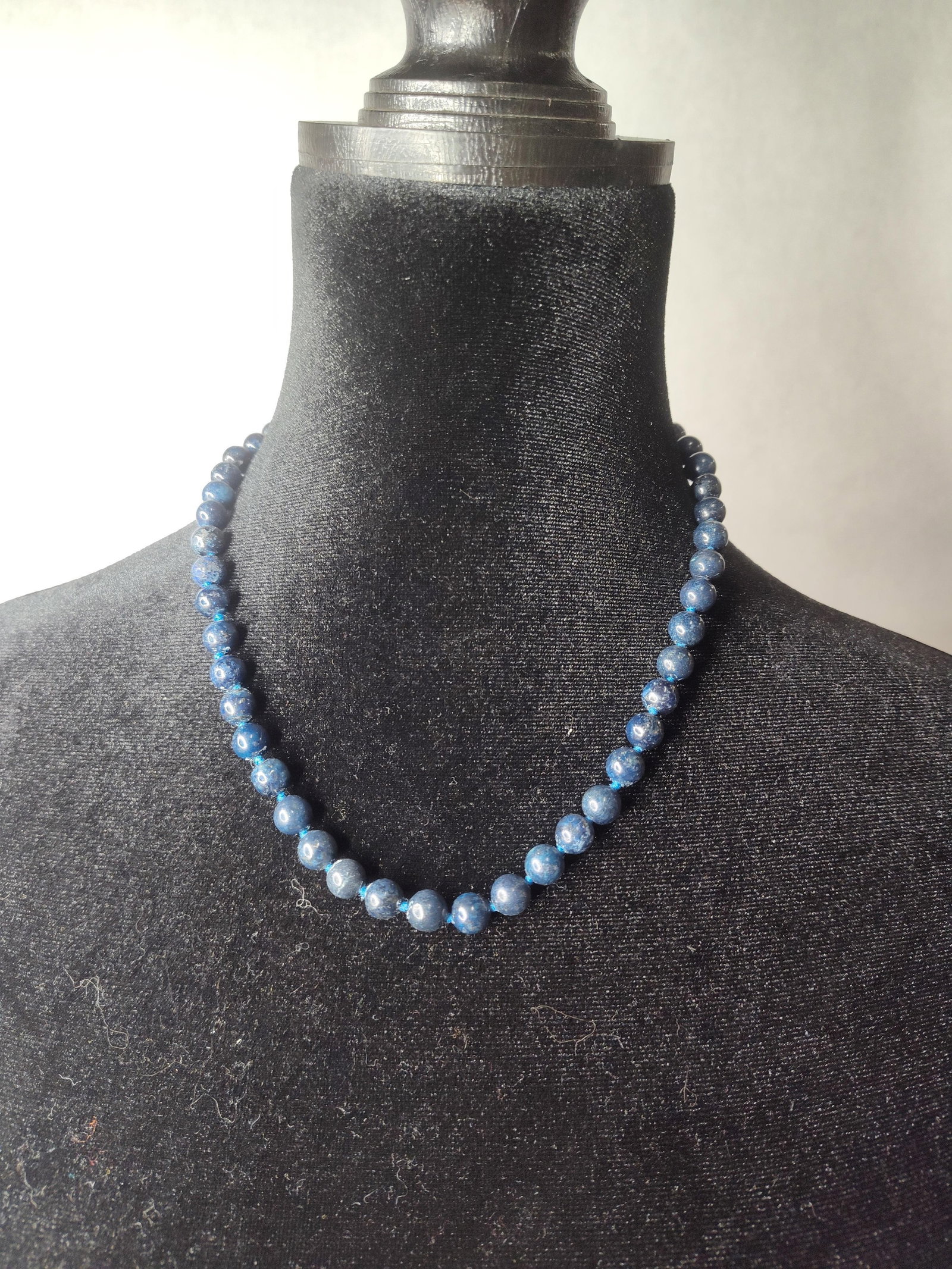Lapis Lazuli Bead Necklace w/ 14K Gold: A beaded necklace featuring approximately 52 round, polished lapis lazuli beads. The stones exhibit a deep navy blue color with characteristic white and light blue mottling. The beads are