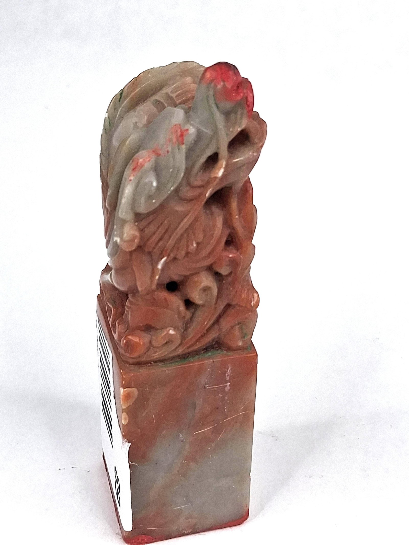 Chinese Carved Shoushan Stone Bird Seal: This hand-carved stone seal is fashioned from mottled soapstone, specifically a variety of Shoushan stone. The material displays natural variations in color including reddish-brown, tan, and