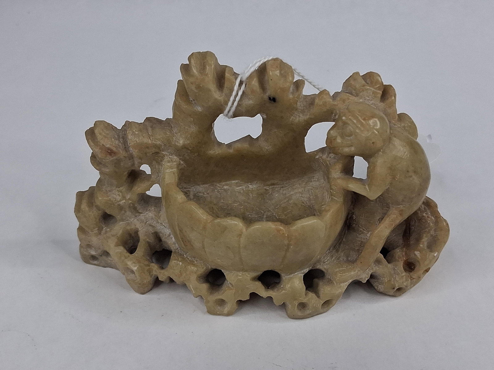 Chinese Soapstone Monkey & Lotus Washer: A Chinese hand-carved soapstone brush washer or scholar's water pot. The piece is crafted from mottled tan and beige steatite with natural cream and light brown variegations. The central feature is a 