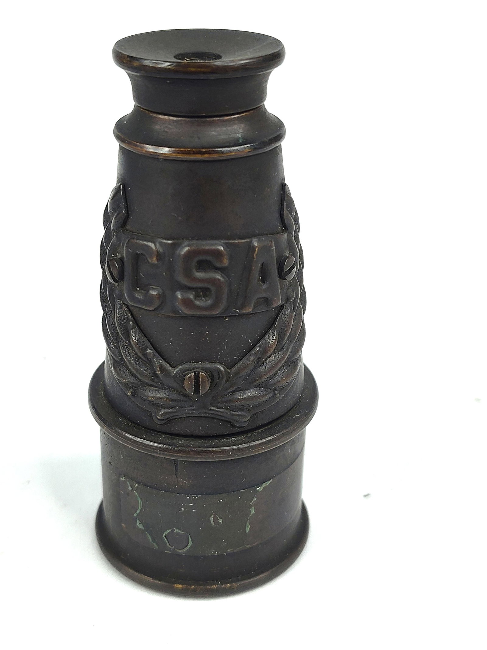 Brass Monocular w/ Confederate Badge: A single-draw monocular featuring a tapered brass body with a dark brown oxidized patina. The central section of the barrel displays an applied cast metal badge secured by three slotted screws. The