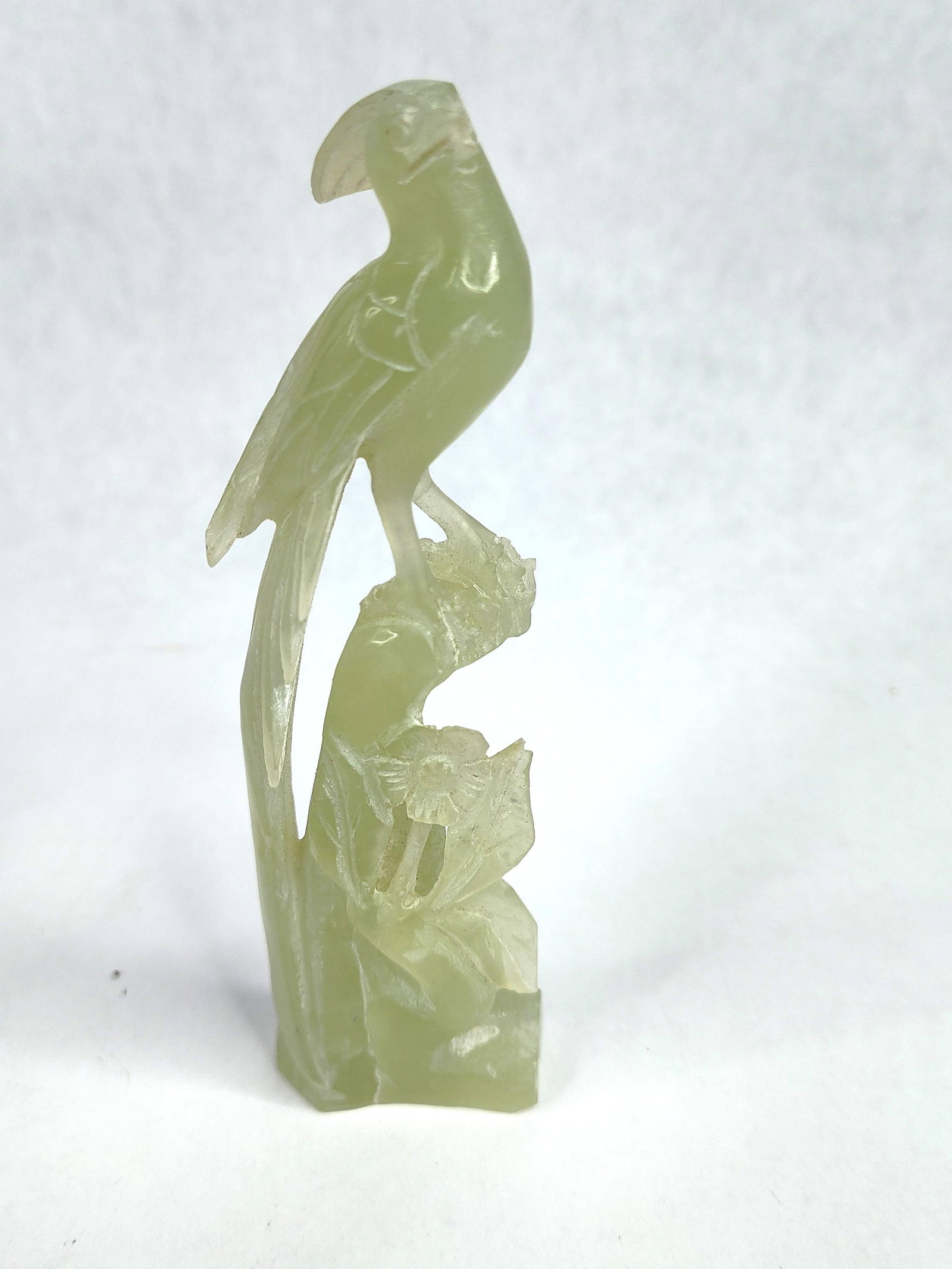 Chinese Carved Serpentine Bird Figurine: A Chinese hand-carved stone figurine representing a crested bird, possibly a bird of paradise or cockatoo. The piece is fashioned from translucent pale green serpentine, also known as bowenite or new 