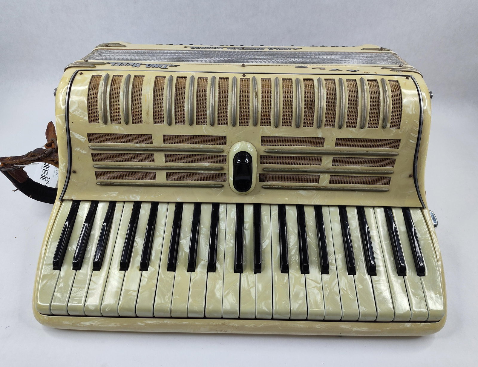Italo American Tina 120 Piano Accordion: A mid-century piano accordion manufactured by the Italo American Accordion Mfg. Co. of Chicago, Illinois, and produced in Italy. This Tina Model instrument features a cream-colored pearloid celluloid 