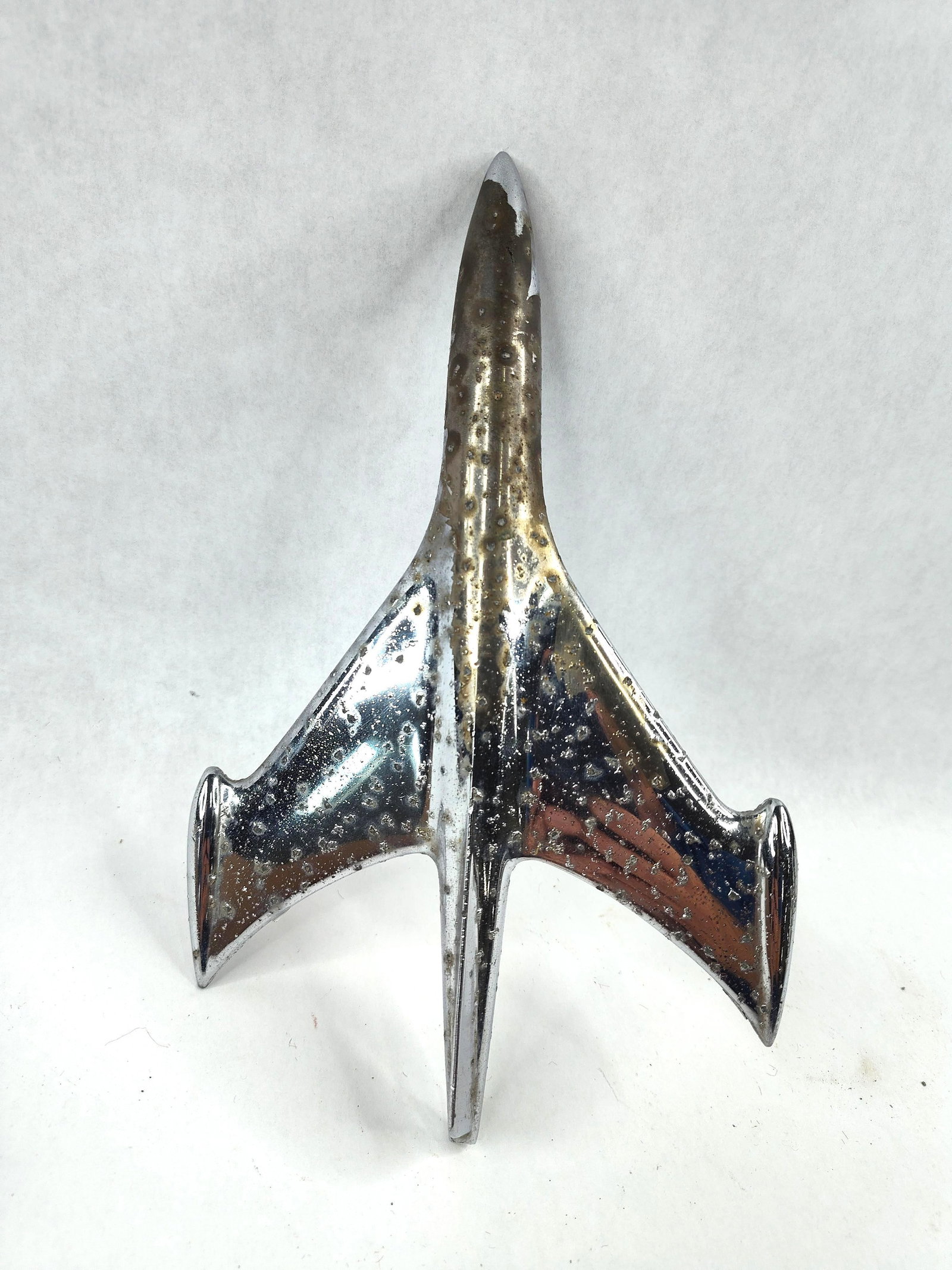1953 Chevrolet Jet Plane Hood Ornament: This is an original automotive mascot, commonly known as a hood ornament, designed for 1953 Chevrolet passenger vehicles. The piece features a stylized jet-age aerodynamic design, reflecting the mid-c