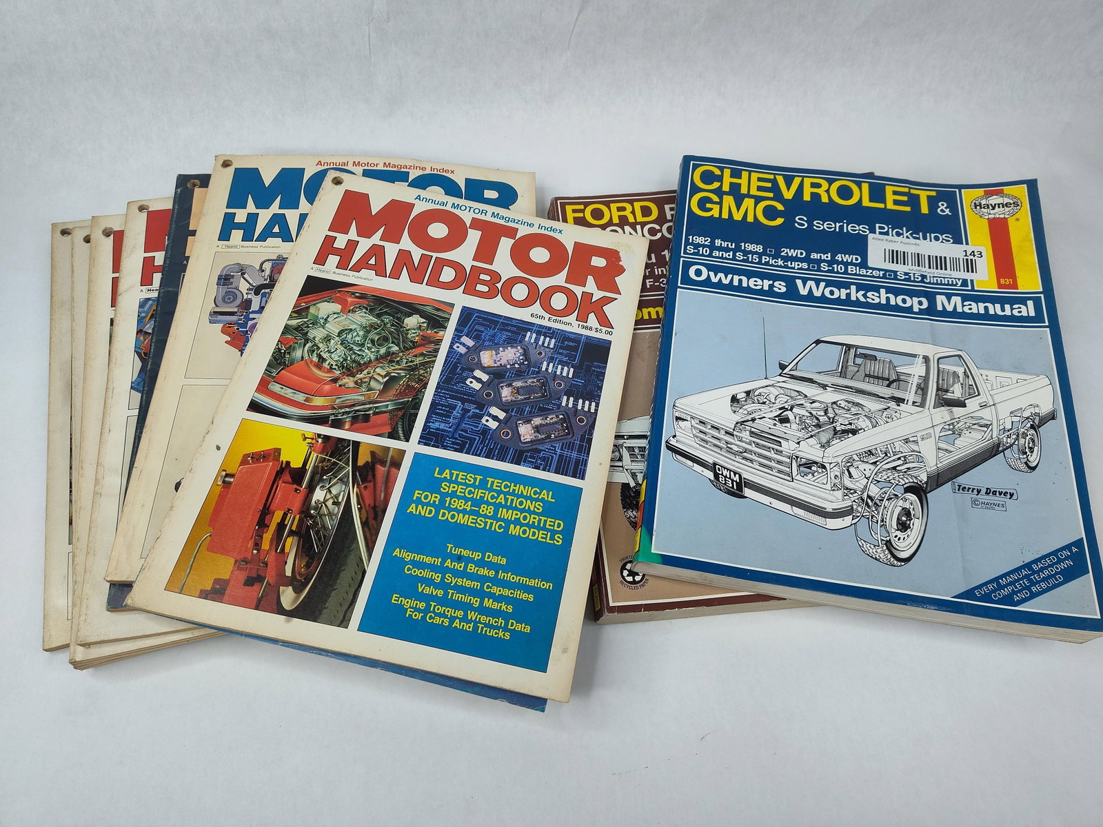9 Vtg Haynes Ford Chevrolet GMC Manuals: An assortment of nine automotive technical manuals and service guides primarily focused on domestic trucks and general specifications from the 1970s and 1980s. The collection includes two Haynes Autom