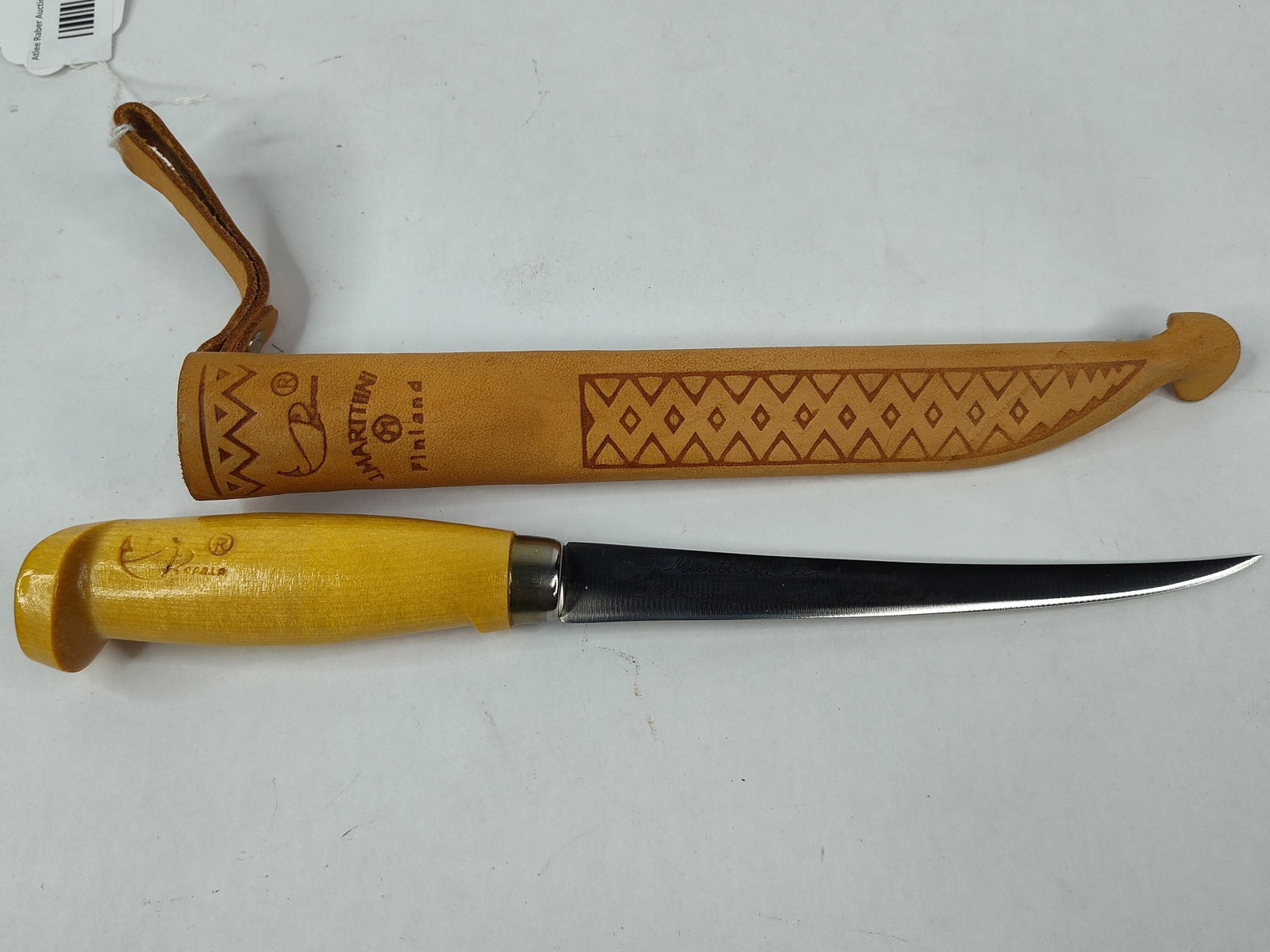 ... no, that's already counted: A Finnish fixed-blade fillet knife manufactured by J. Marttiini for Rapala. The blade is constructed of hand-ground stainless steel and features cursive script inscriptions on one side reading J.