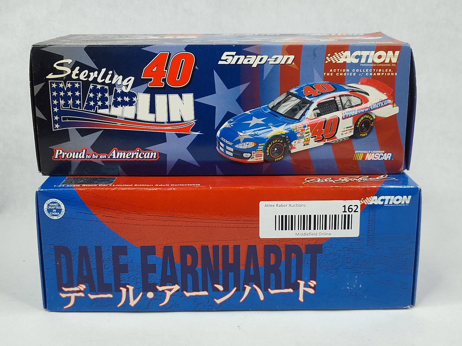 Action 1:24 NASCARs: Marlin & Earnhardt: Two 1:24 scale die-cast model NASCAR stock cars manufactured by Action Performance Companies, Inc. The first item is a Sterling Marlin #40 Dodge Intrepid featuring the Proud to be an American patrioti