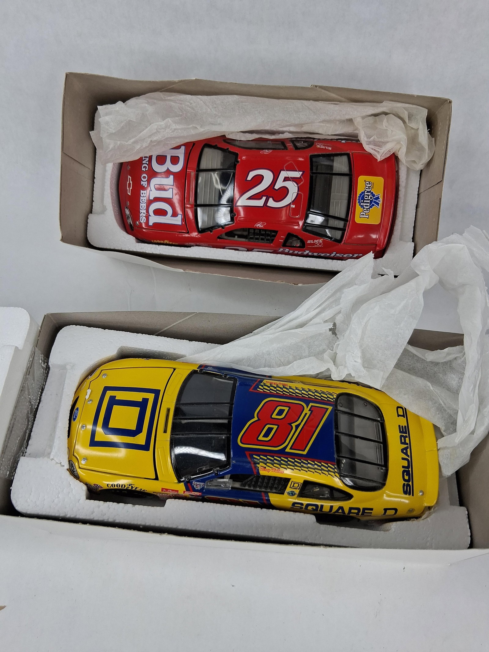 Pair Action Racing NASCAR Die-Cast Cars: This lot features two limited edition 1:24 scale NASCAR die-cast stock cars manufactured by Action Racing Collectables, a division of Action Performance Companies, Inc. The first vehicle is a Ricky Cr